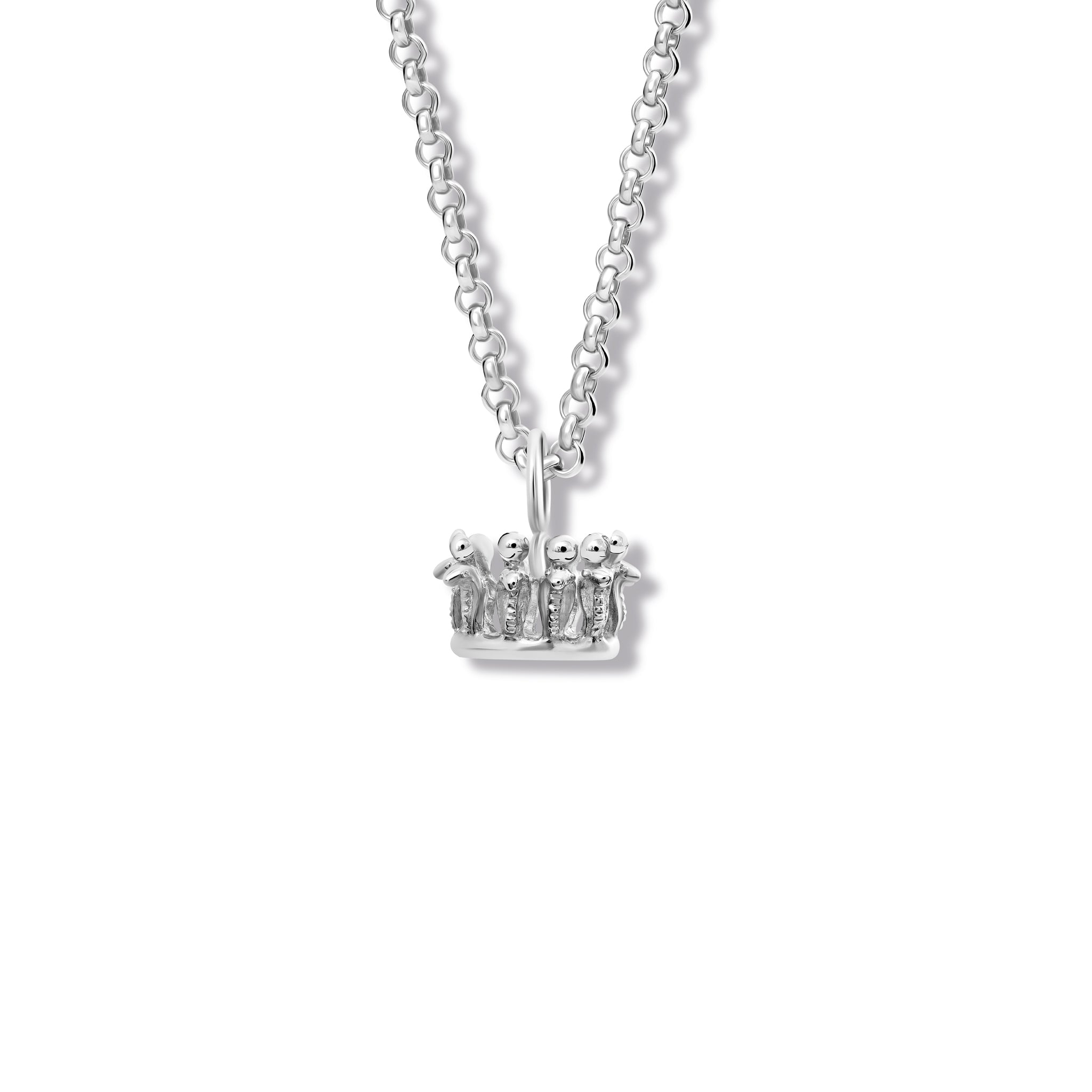 A crown-shaped necklace pendant in precious metal, hanging from a necklace chain.