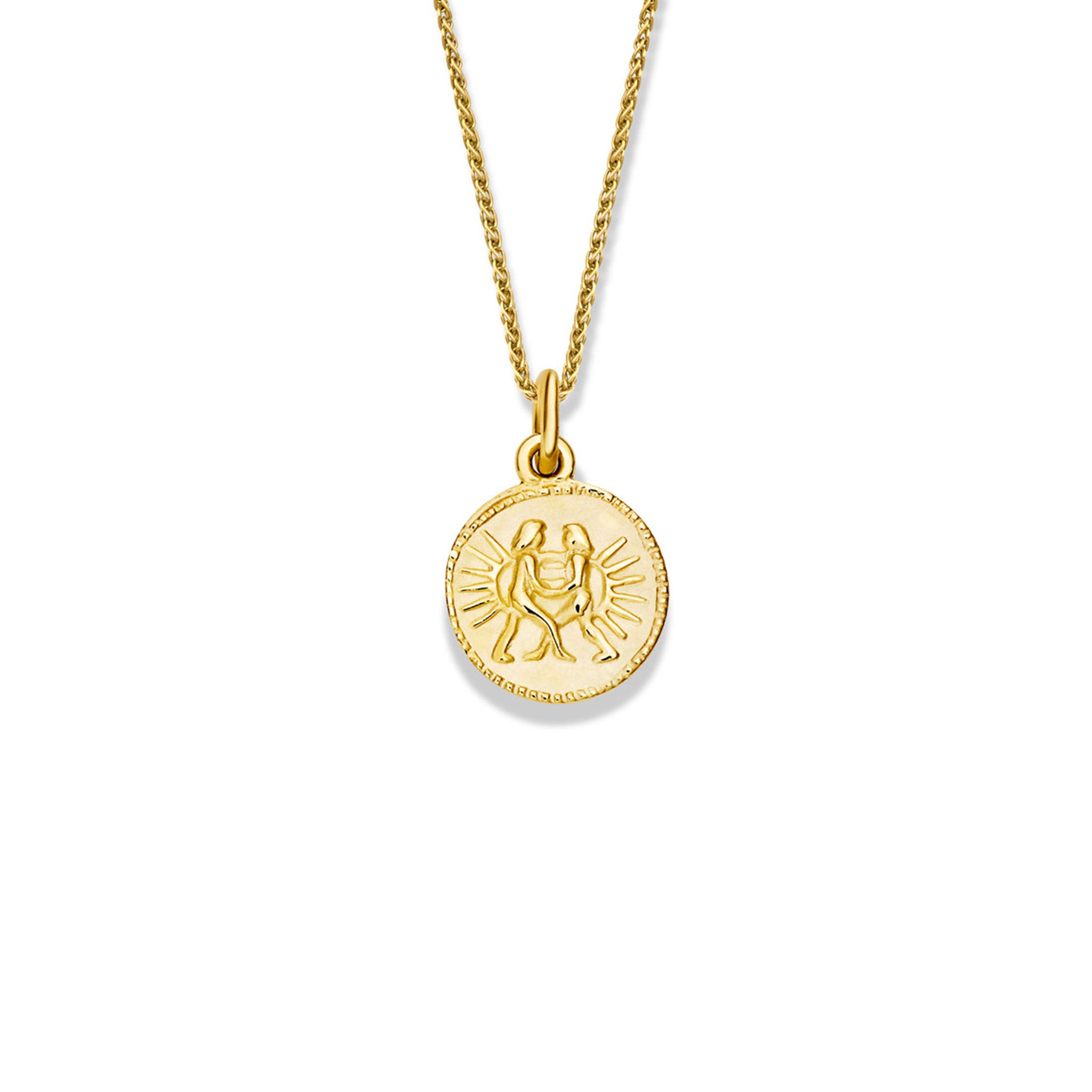 Handcrafted round yellow gold necklace pendant engraved with the zodiac gemini.