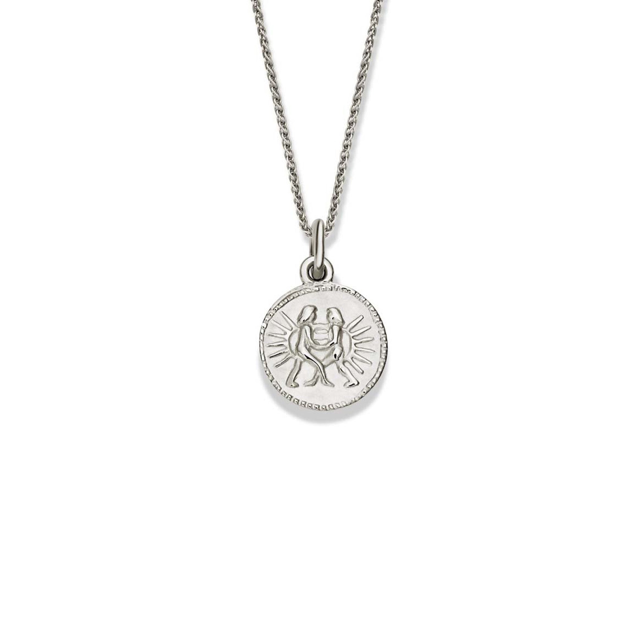 Handcrafted round sterling silver necklace pendant engraved with the zodiac gemini.