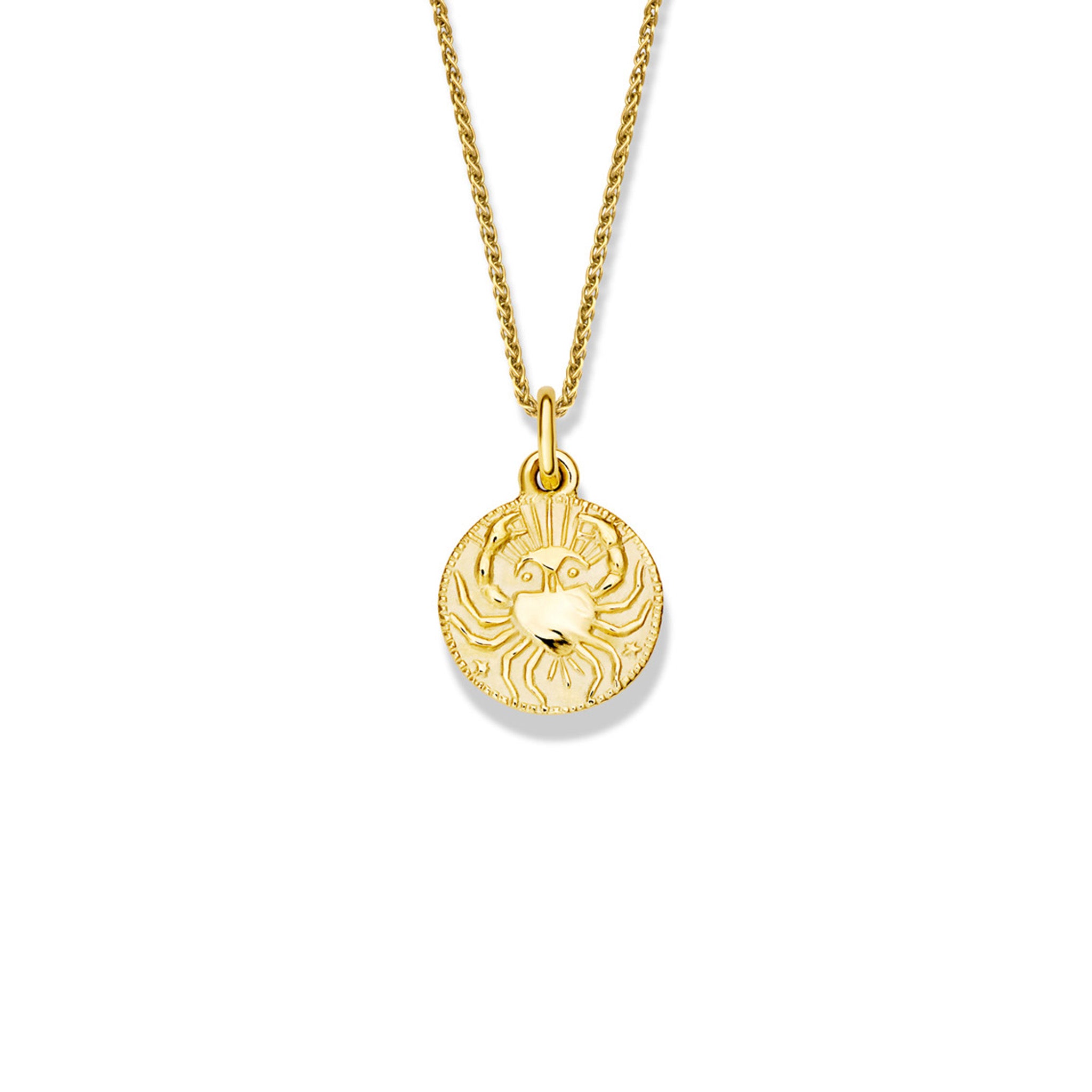 Handcrafted round yellow gold necklace pendant engraved with the zodiac cancer.