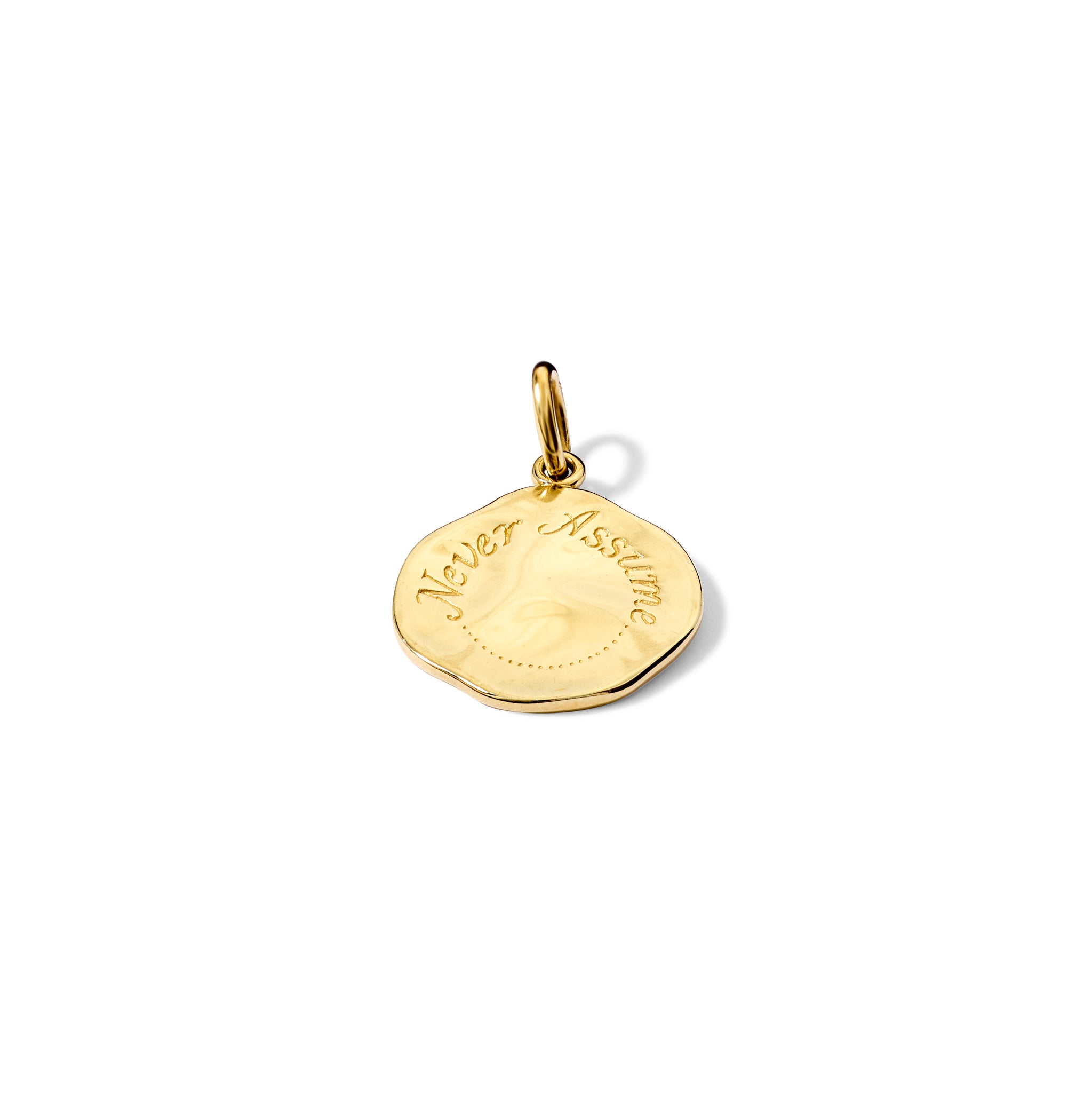 Handcrafted yellow gold necklace pendant engraved with the quote, 'Never Assume.' 