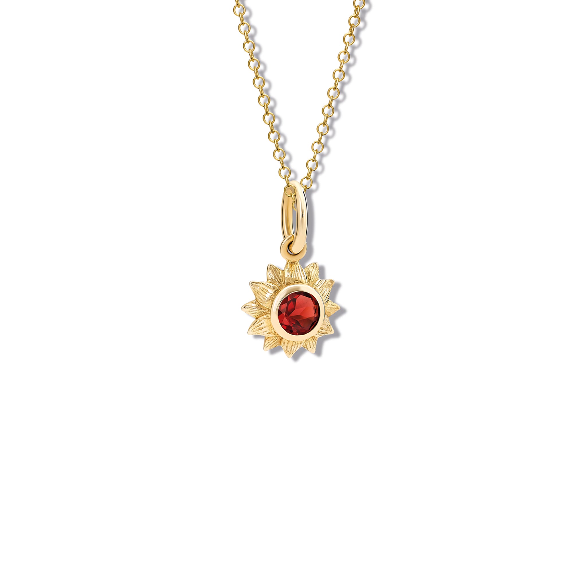 Handcrafted yellow gold sunflower necklace pendant featuring a central garnet, birthstone of January.