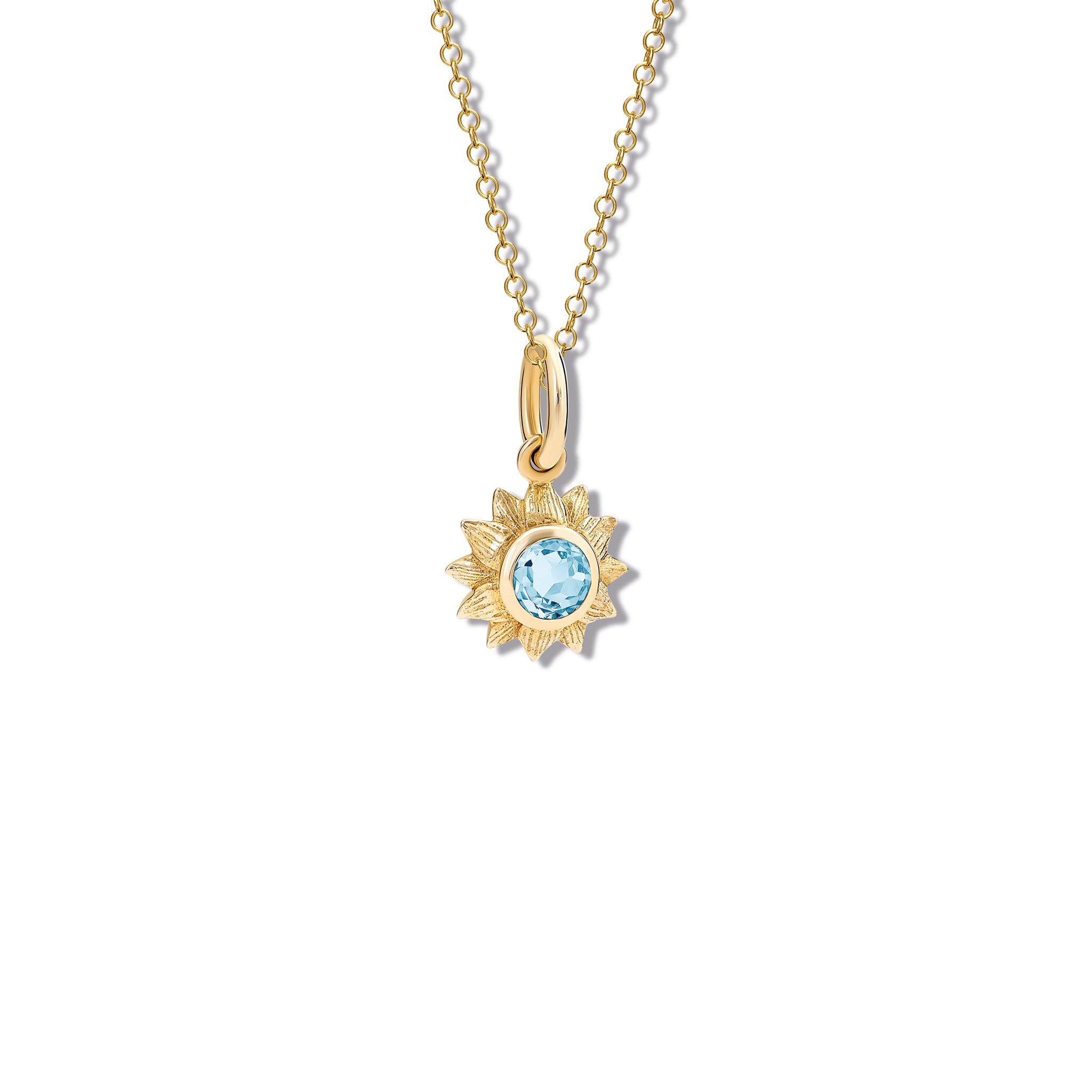 Handcrafted yellow gold sunflower necklace pendant featuring a central blue topaz, birthstone of November.