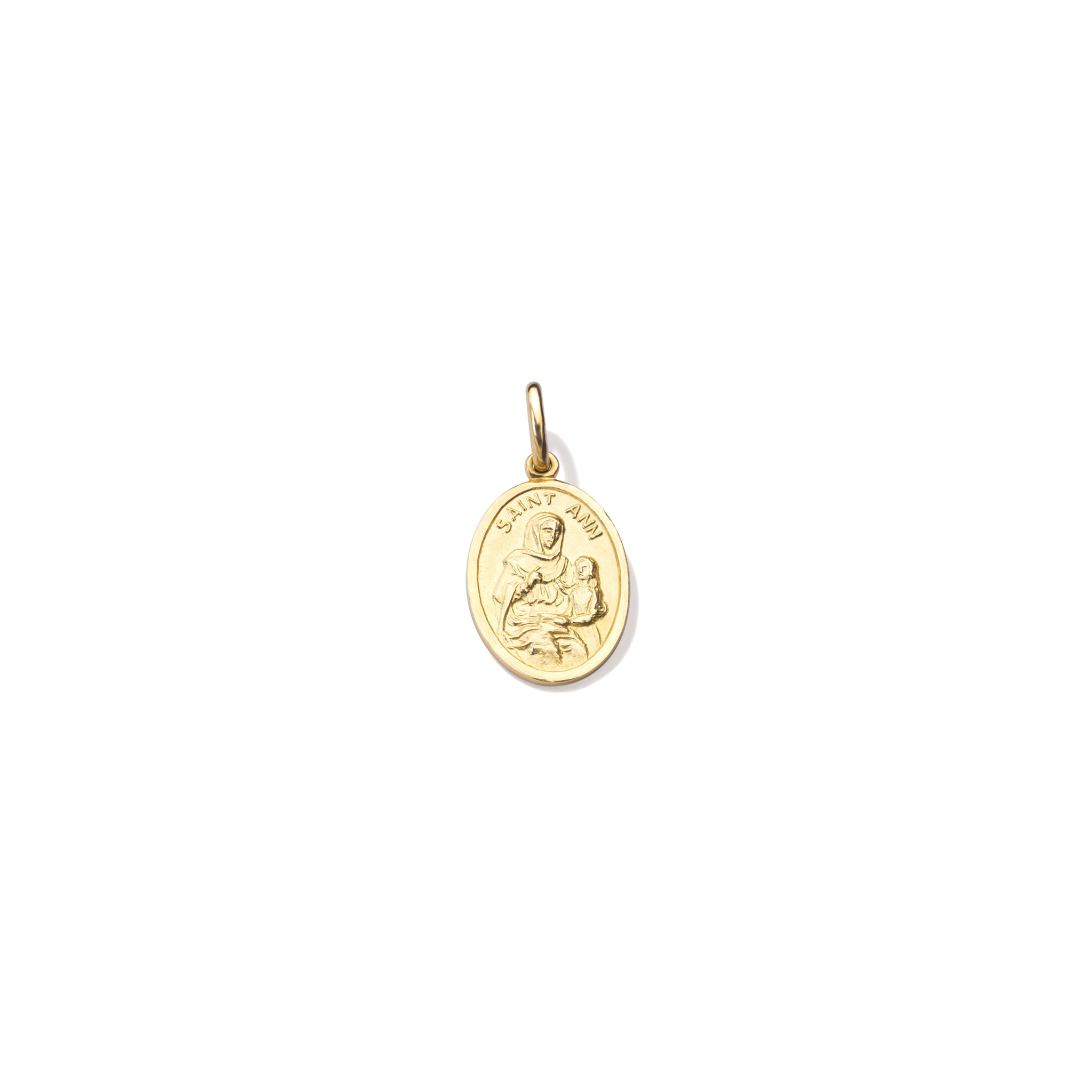 Handcrafted oval yellow gold pendant with an engraving of Saint Anne cradling a child and 'Saint Anne' inscribed above. Includes a top loop for chain attachment.