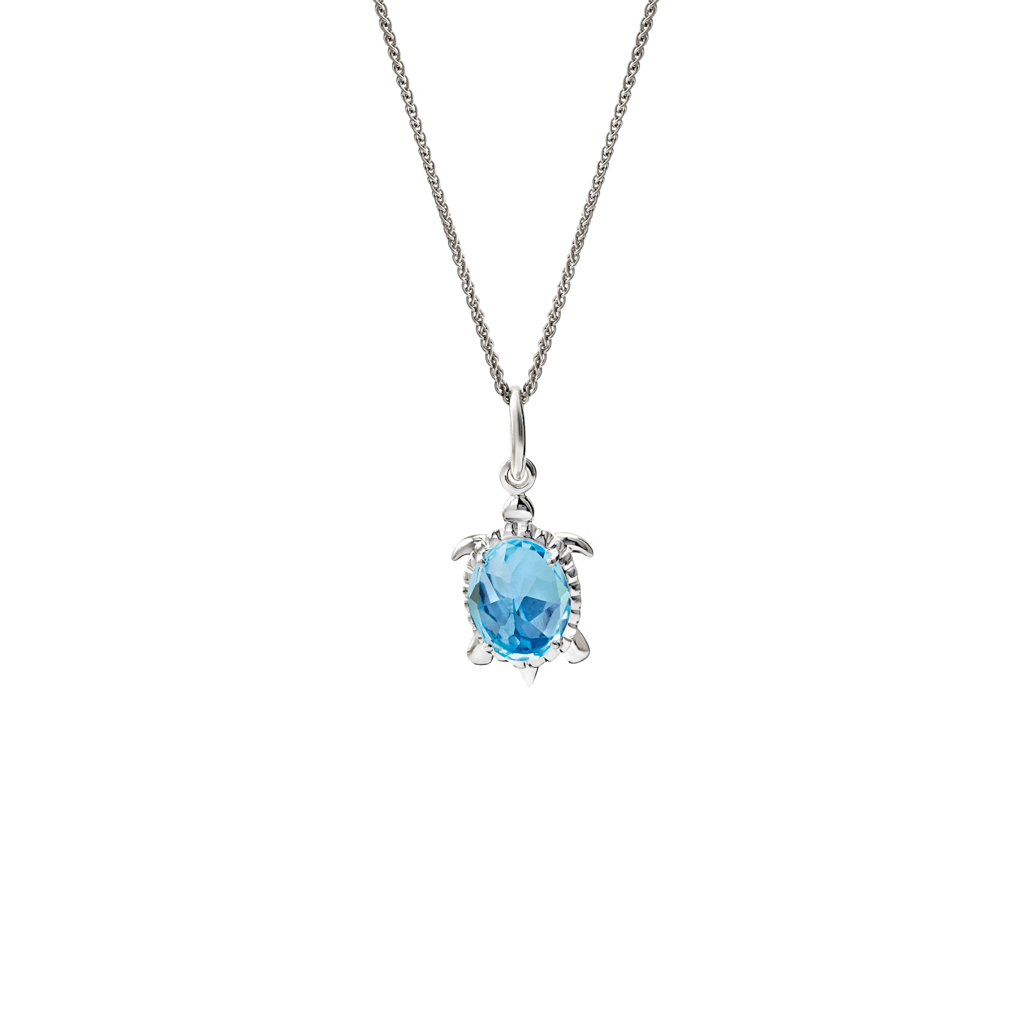 Handcrafted sterling silver turtle shaped necklace pendant featuring blue topaz.
