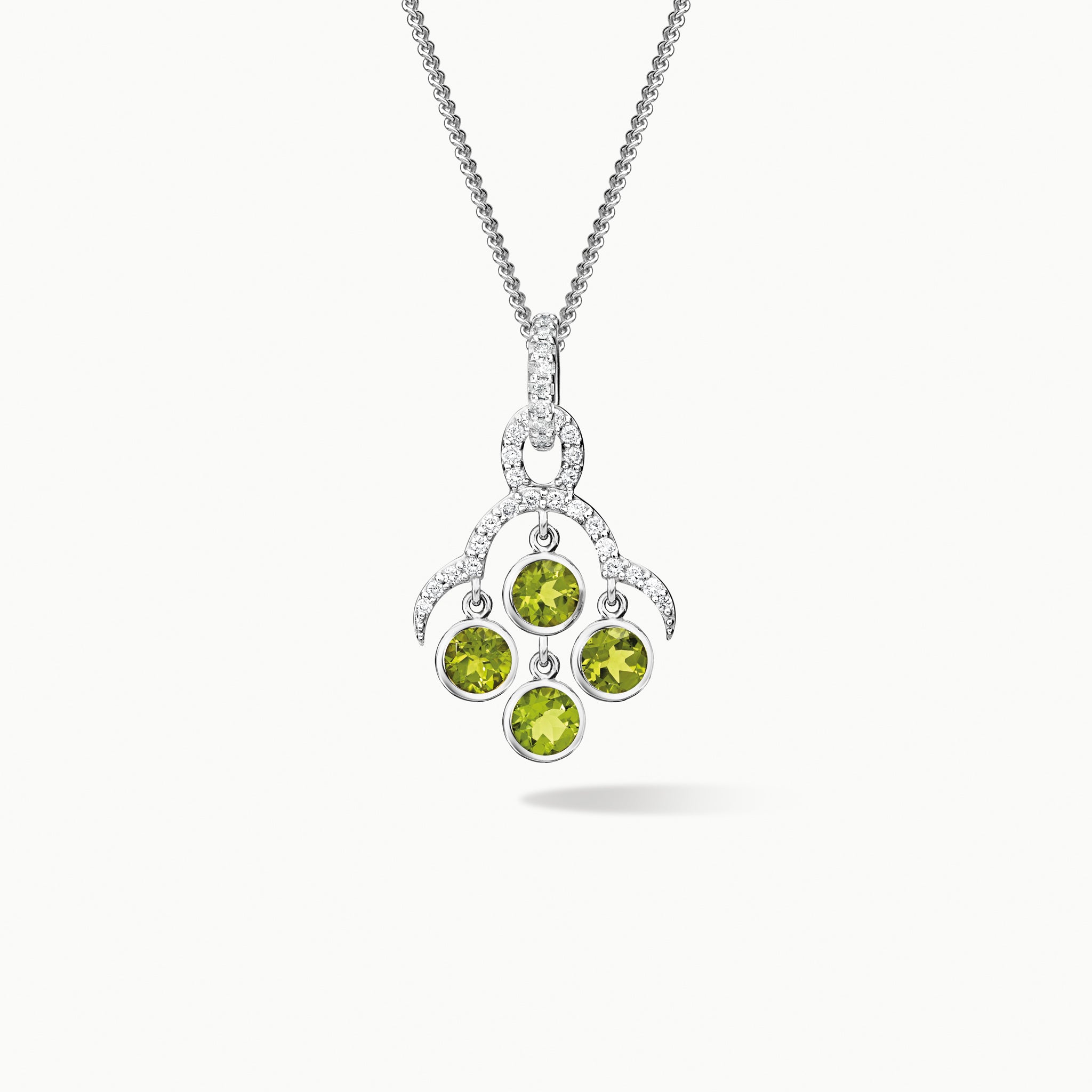 Handcrafted white gold necklace pendant inspired by acai berries featuring four peridot gemstones and diamonds, on a chain.