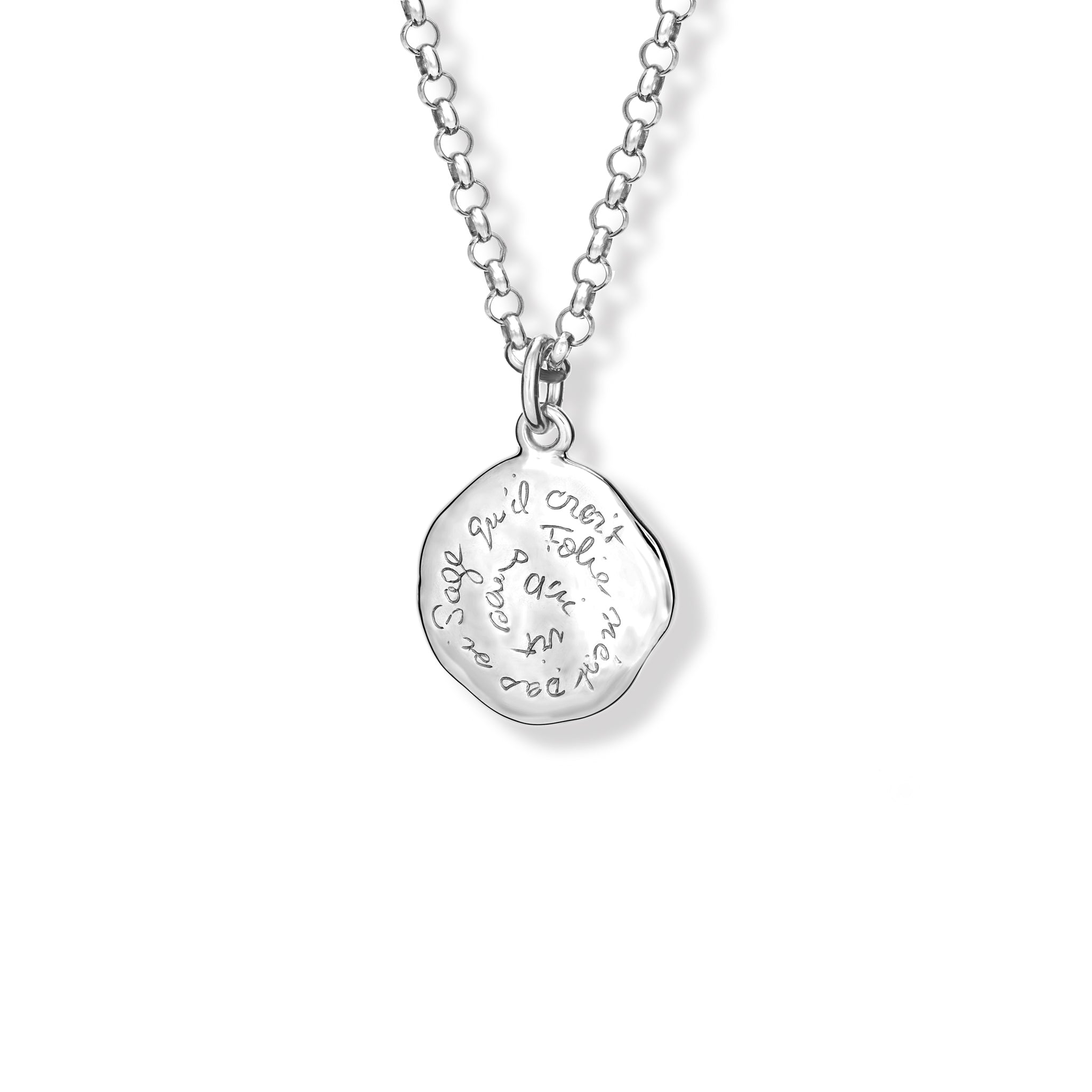 Handcrafted sterling silver necklace pendant engraved with the quote, 'Qui vit sans folie n'est pas si sage qu'il croit.' 
