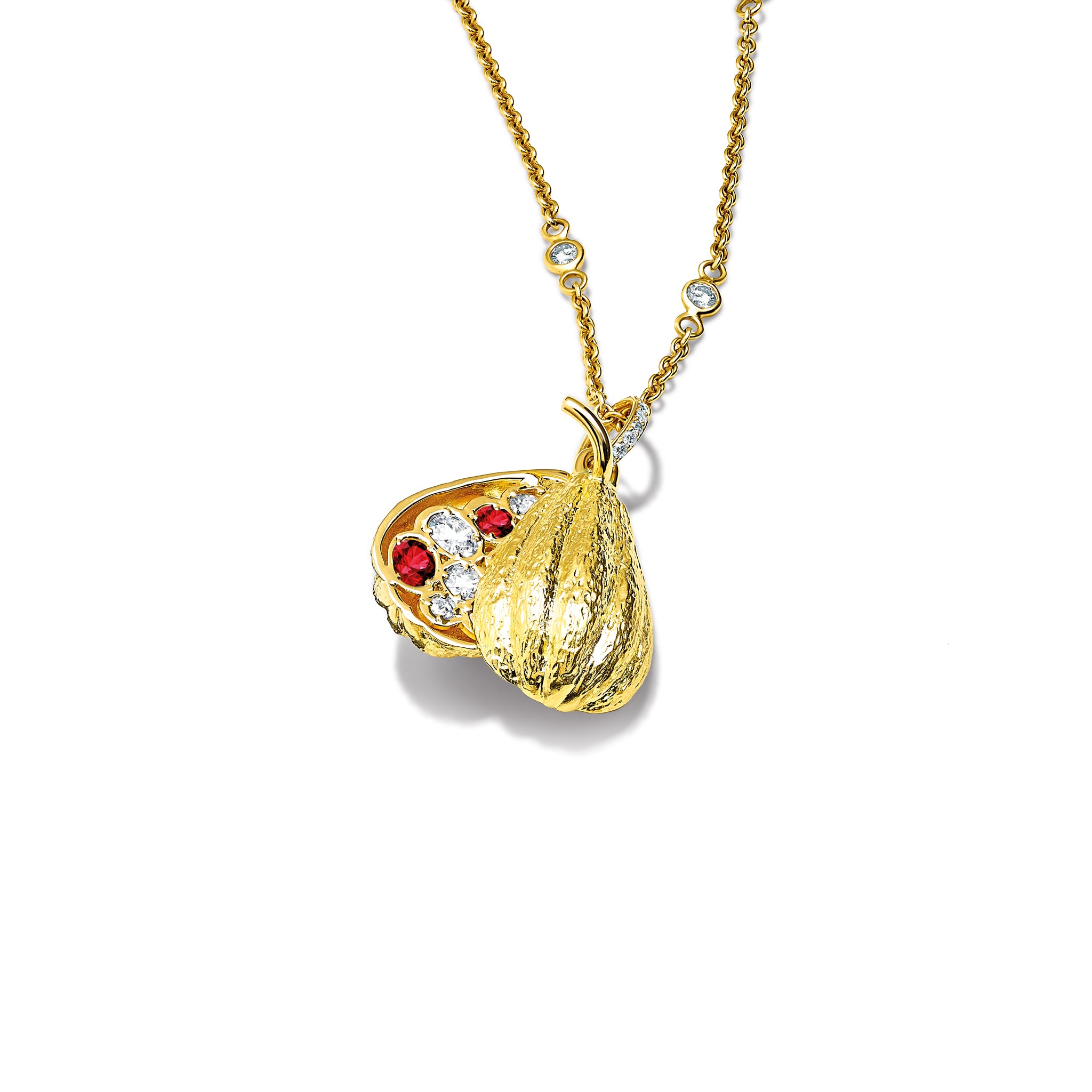 Handcrafted 18ct white gold necklace pendant shaped like a cocoa pod, revealing small rubies and diamonds nestled inside, the birthstone of July.