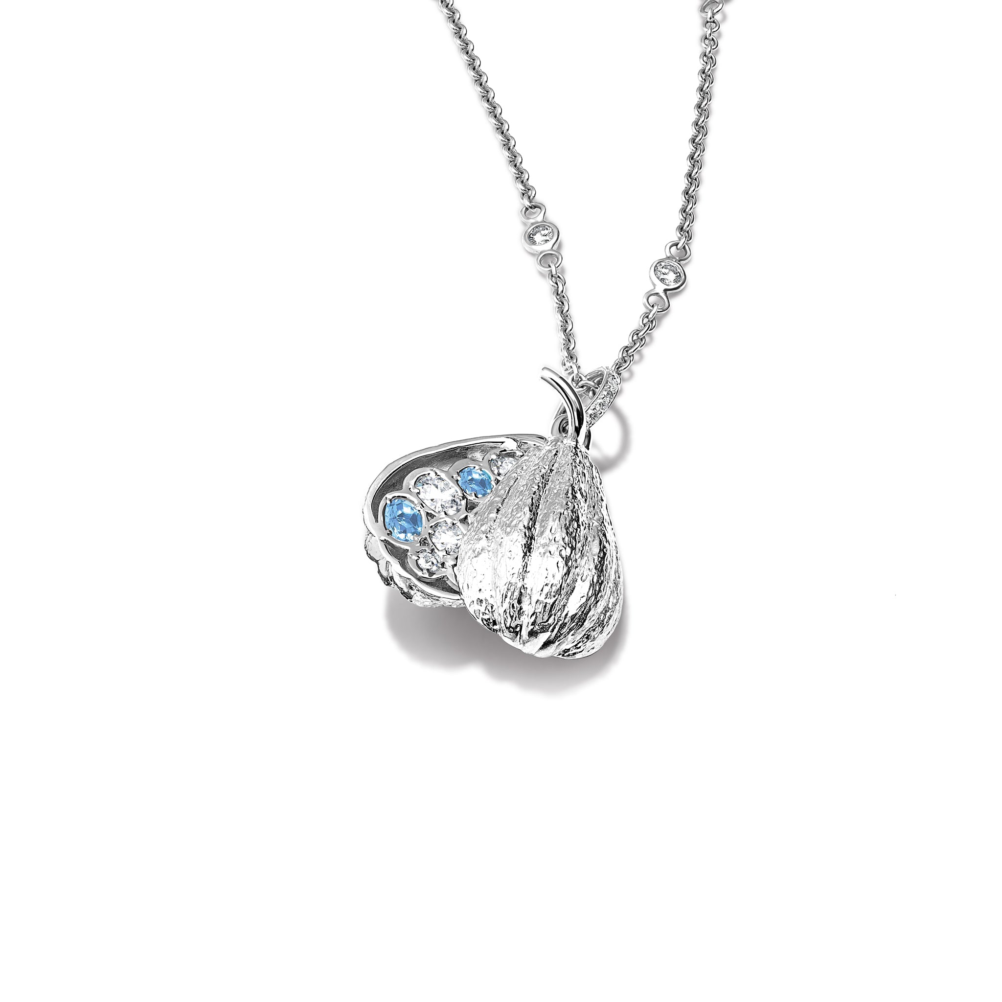 Handcrafted 18ct white gold necklace pendant shaped like a cocoa pod, revealing small sapphires and diamonds nestled inside, birthstone of September.