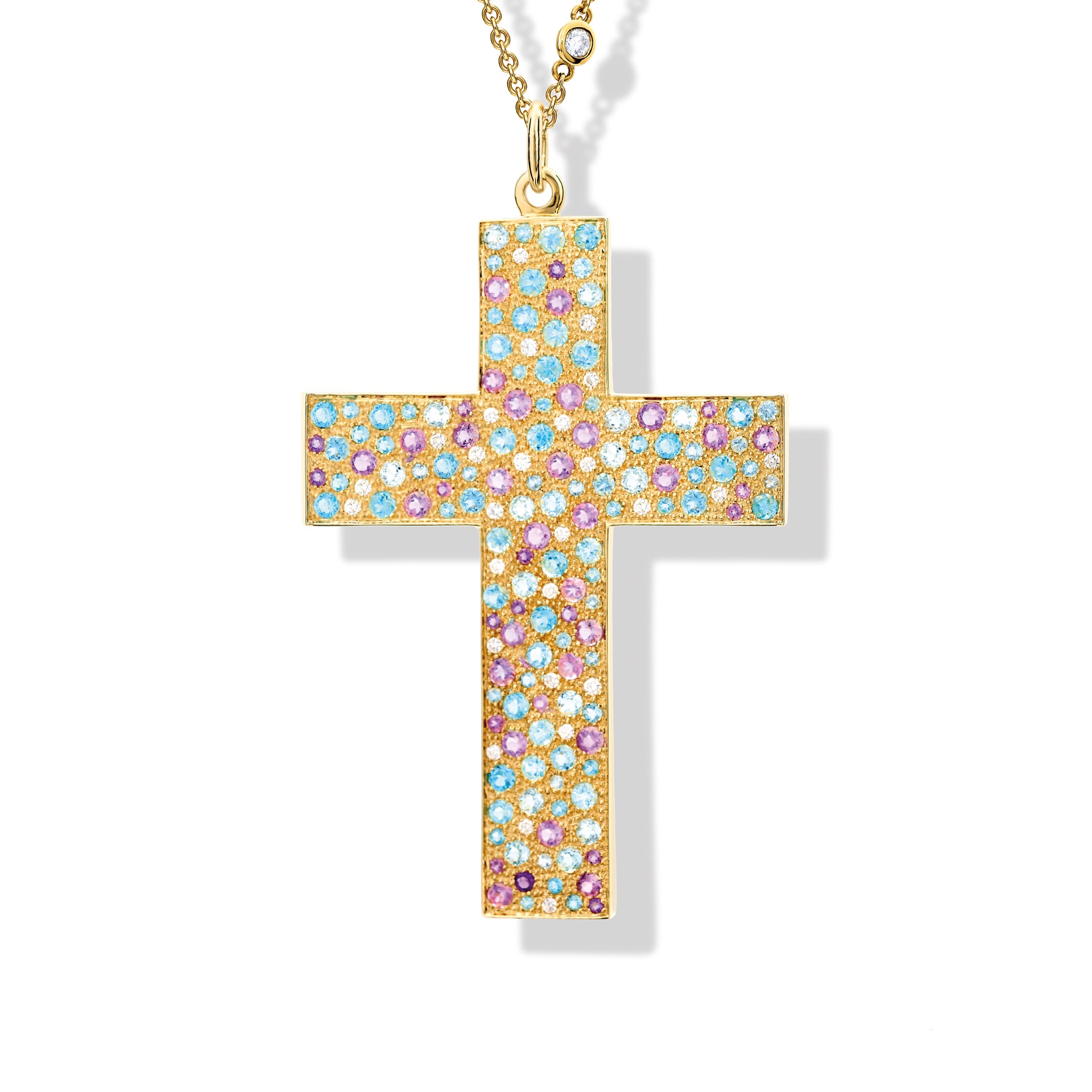 Handcrafted yellow gold cross necklace pendant featuring blue and purple precious stones, with a loop at the top for attaching to a chain.