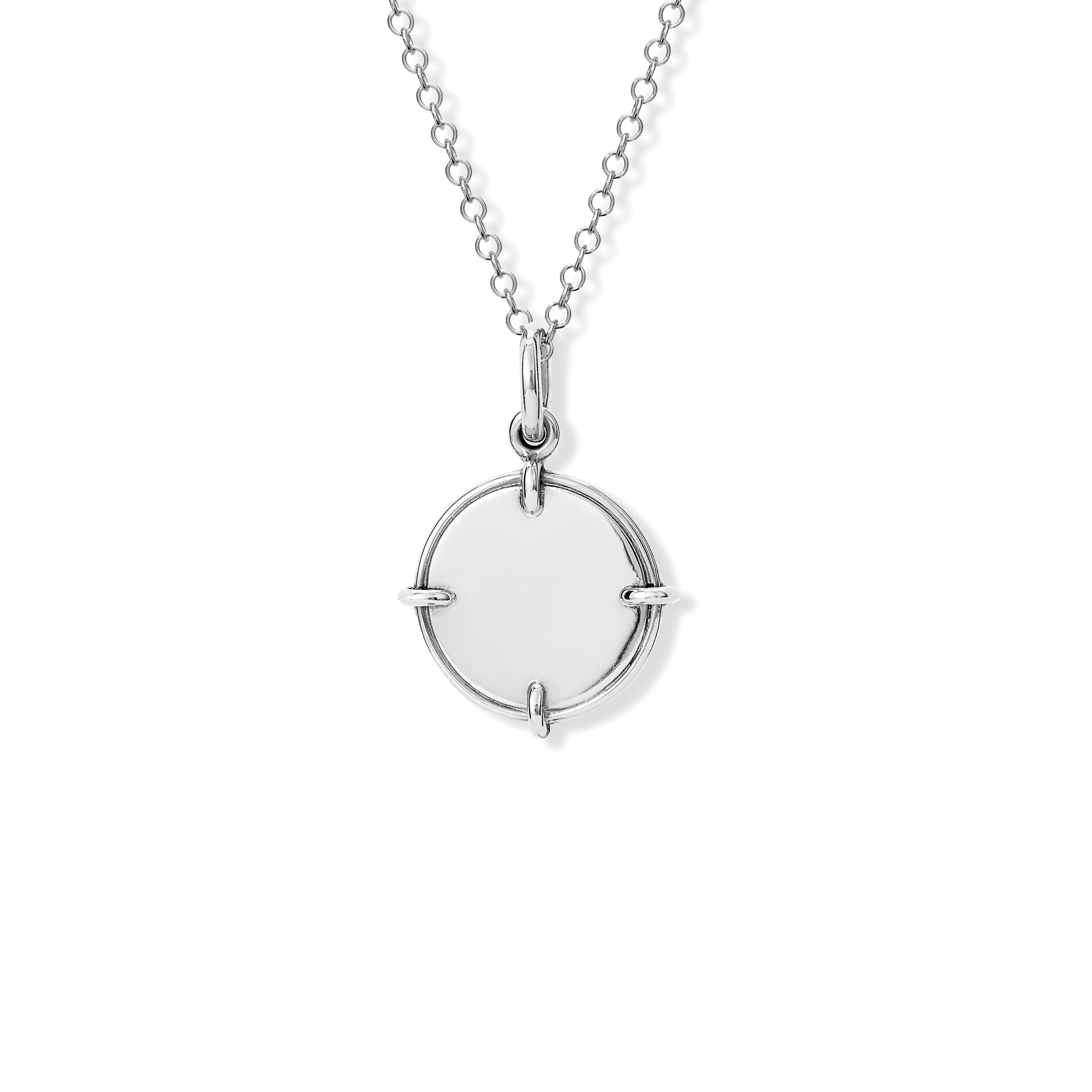 Handcrafted sterling silver necklace pendant featuring a round shape with four points.
