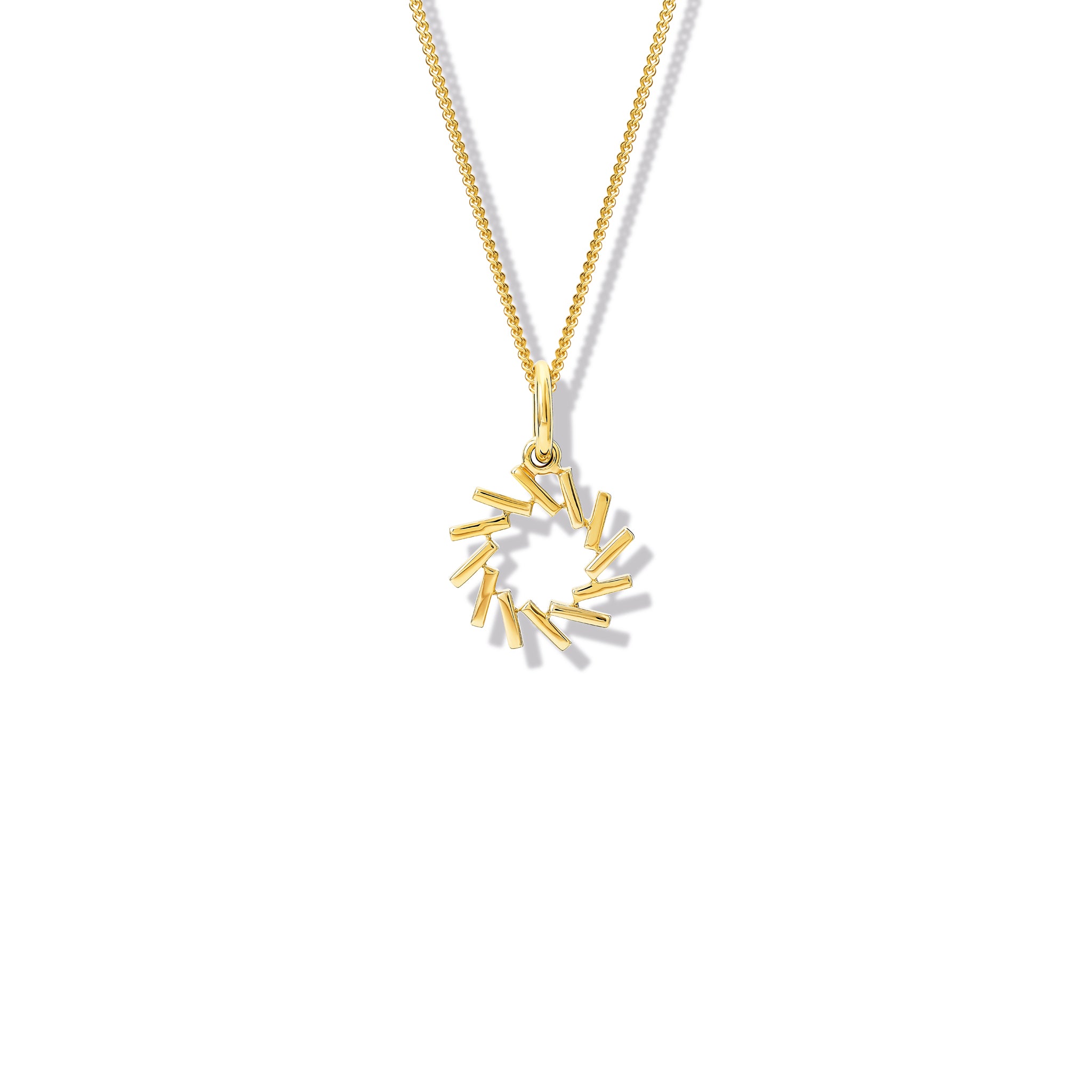 Handcrafted yellow gold necklace pendant featuring a circular shape of diagonal lines.
