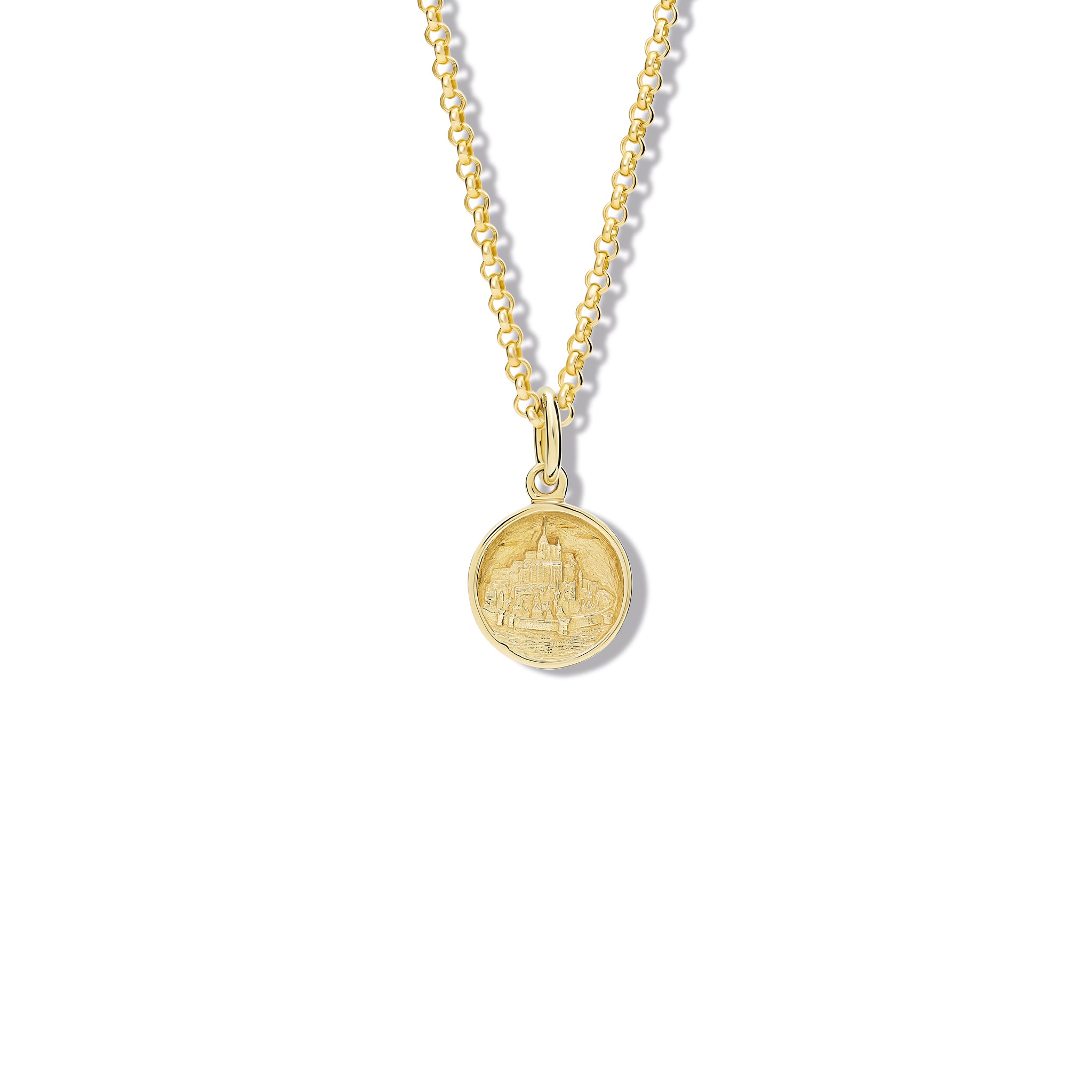 Handcrafted round yellow gold necklace pendant featuring an engraving of Mont Saint-Michel Abbey in France, hanging from a gold chain.