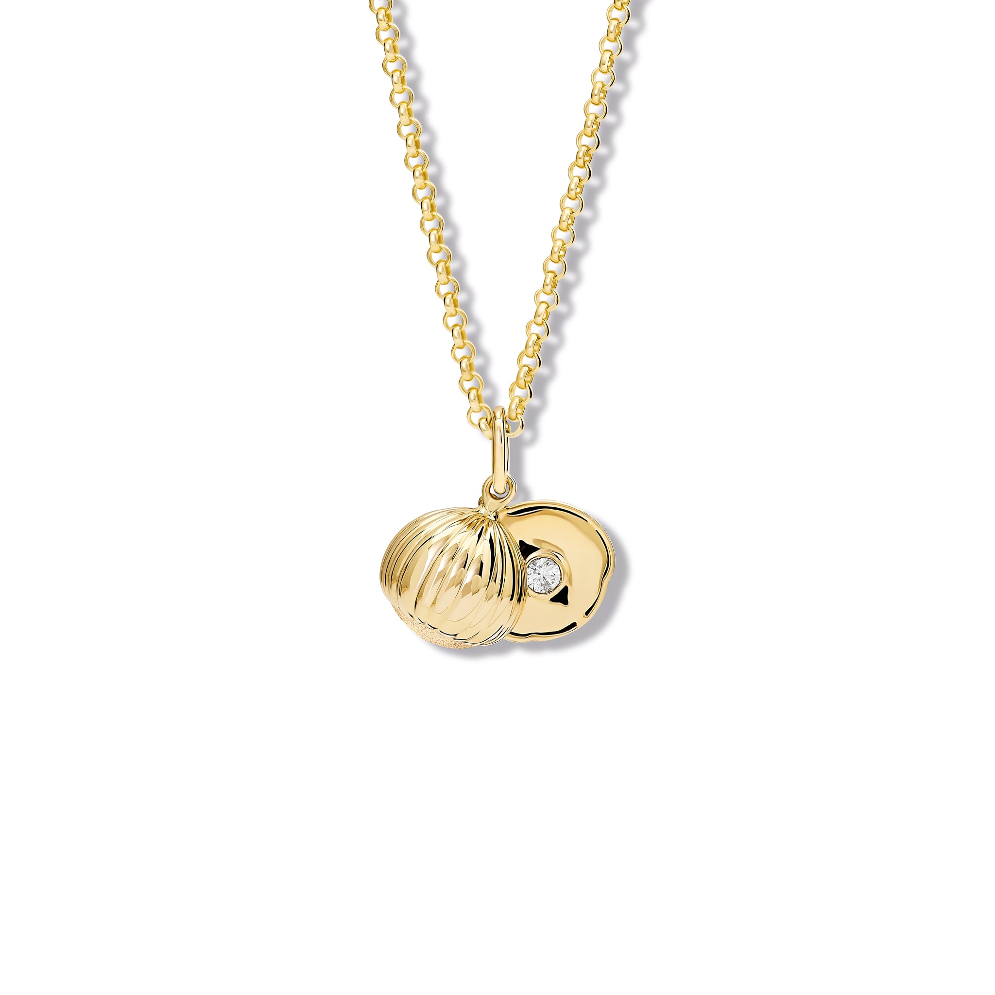 Handcrafted yellow gold necklace pendant with a hazelnut design revealing a diamond, birthstone of April.