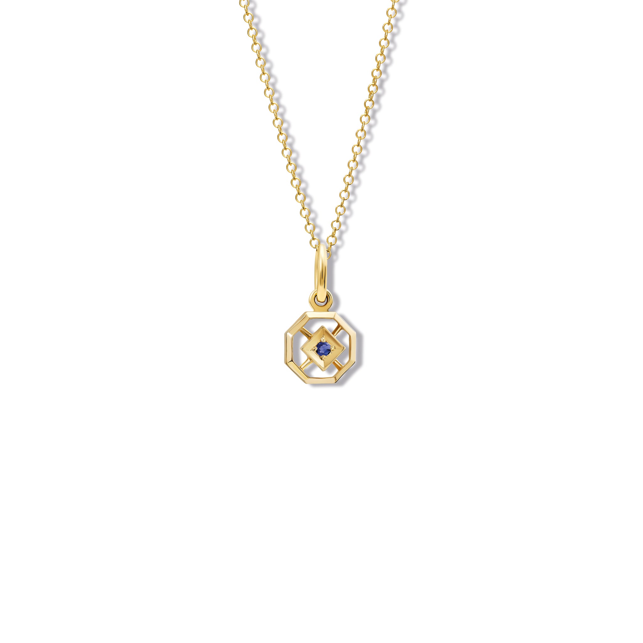 Handcrafted yellow gold necklace pendant featuring an octagonal design with a central sapphire, birthstone of September.