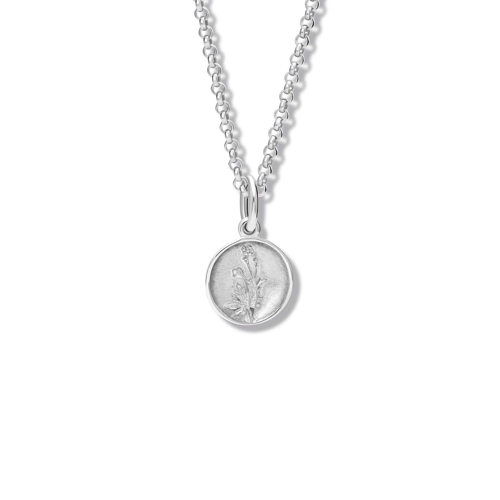 Handcrafted round sterling silver necklace pendant 'en relief' with a buttercup flower.