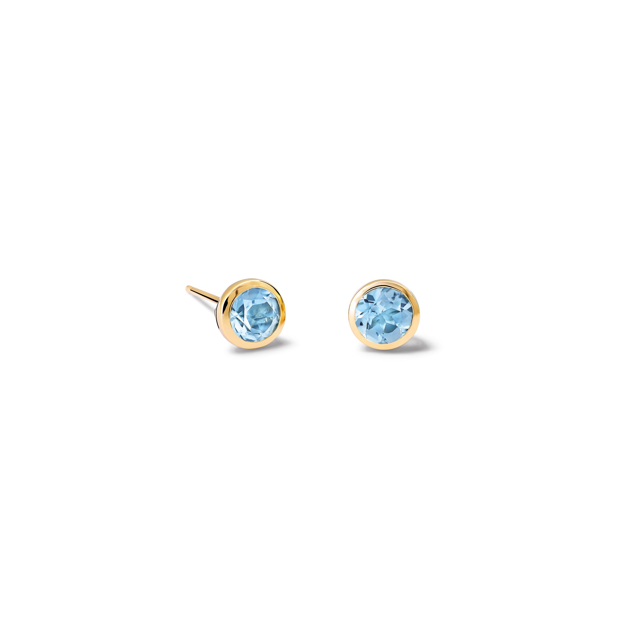 Handcrafted yellow gold stud earrings featuring round blue topaz, birthstone of November.