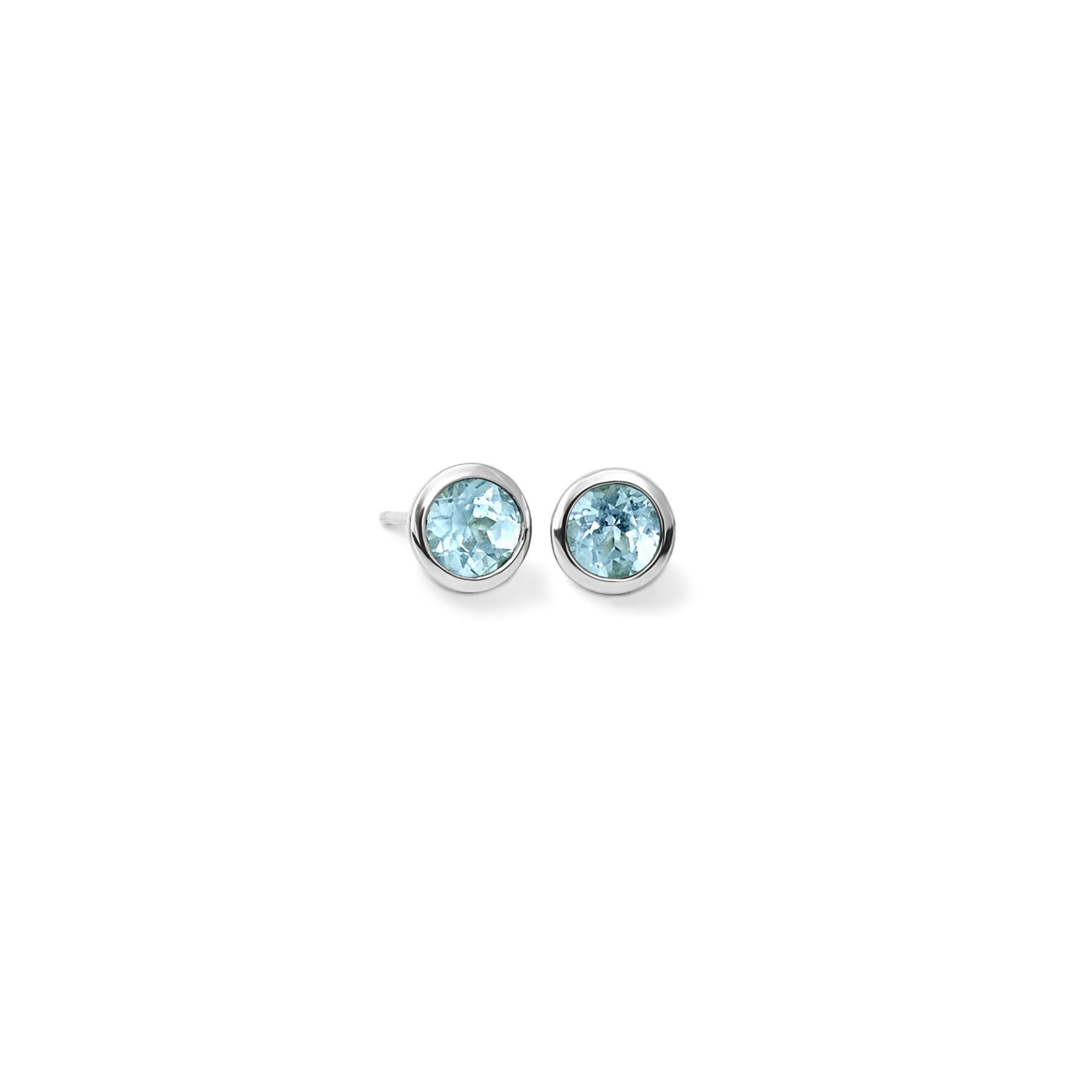 Handcrafted white gold stud earrings featuring round blue topaz, birthstone of November.