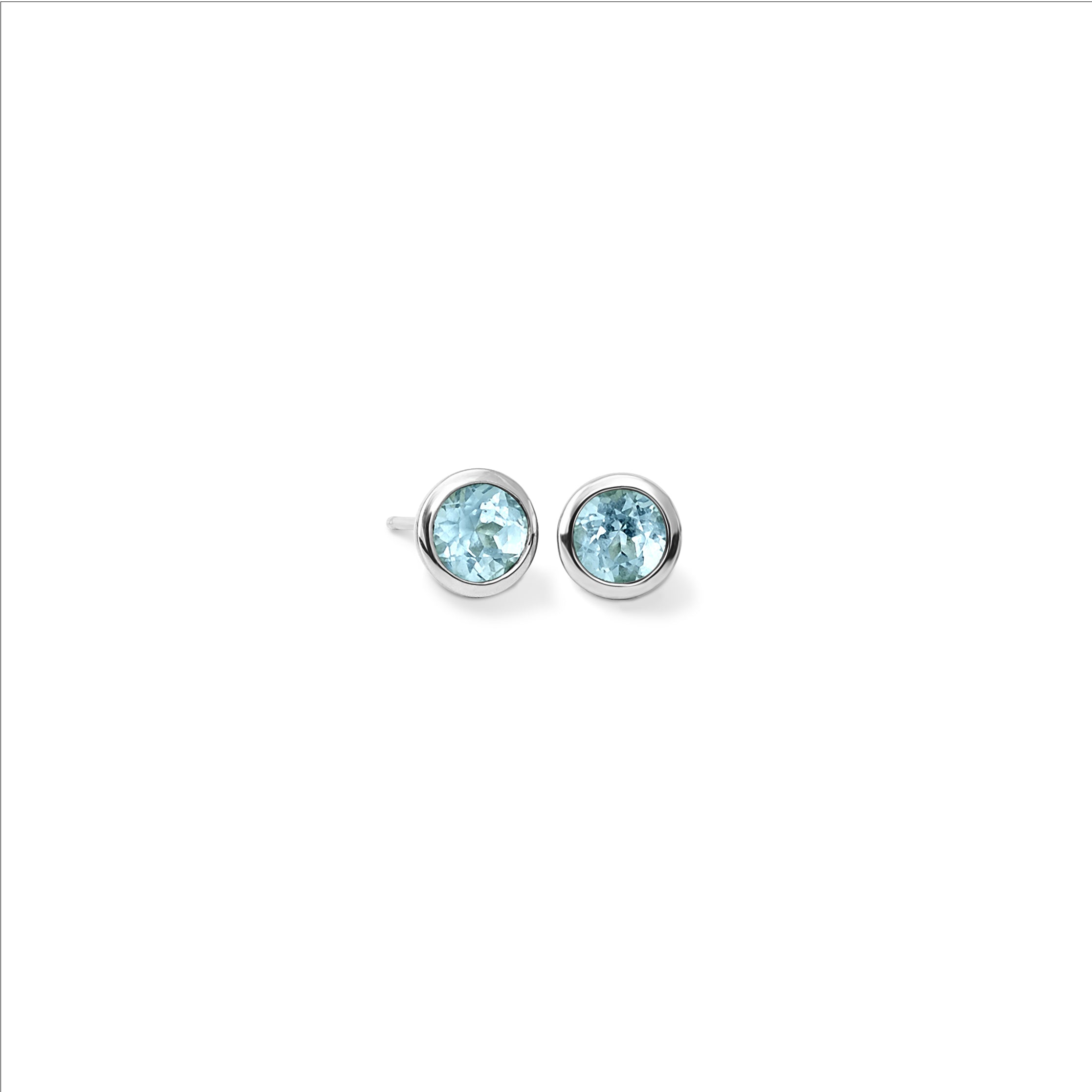 Handcrafted white gold stud earrings featuring round blue topaz, birthstone of November.