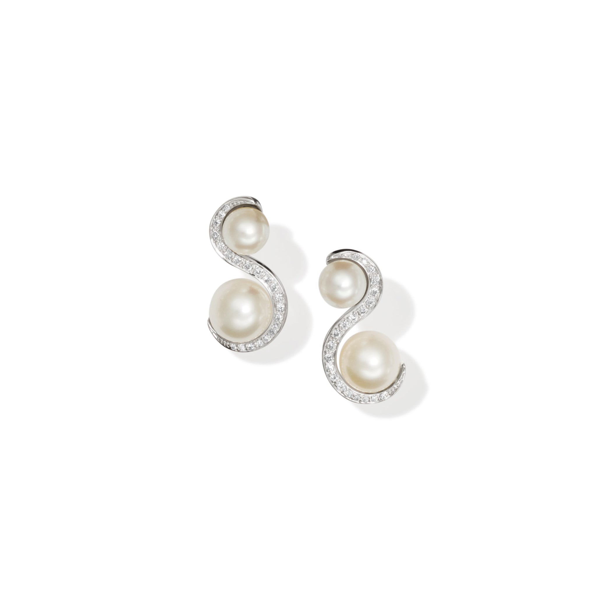 Handcrafted 18ct white gold earrings featuring an 's' shape linking the pearls with diamonds.
