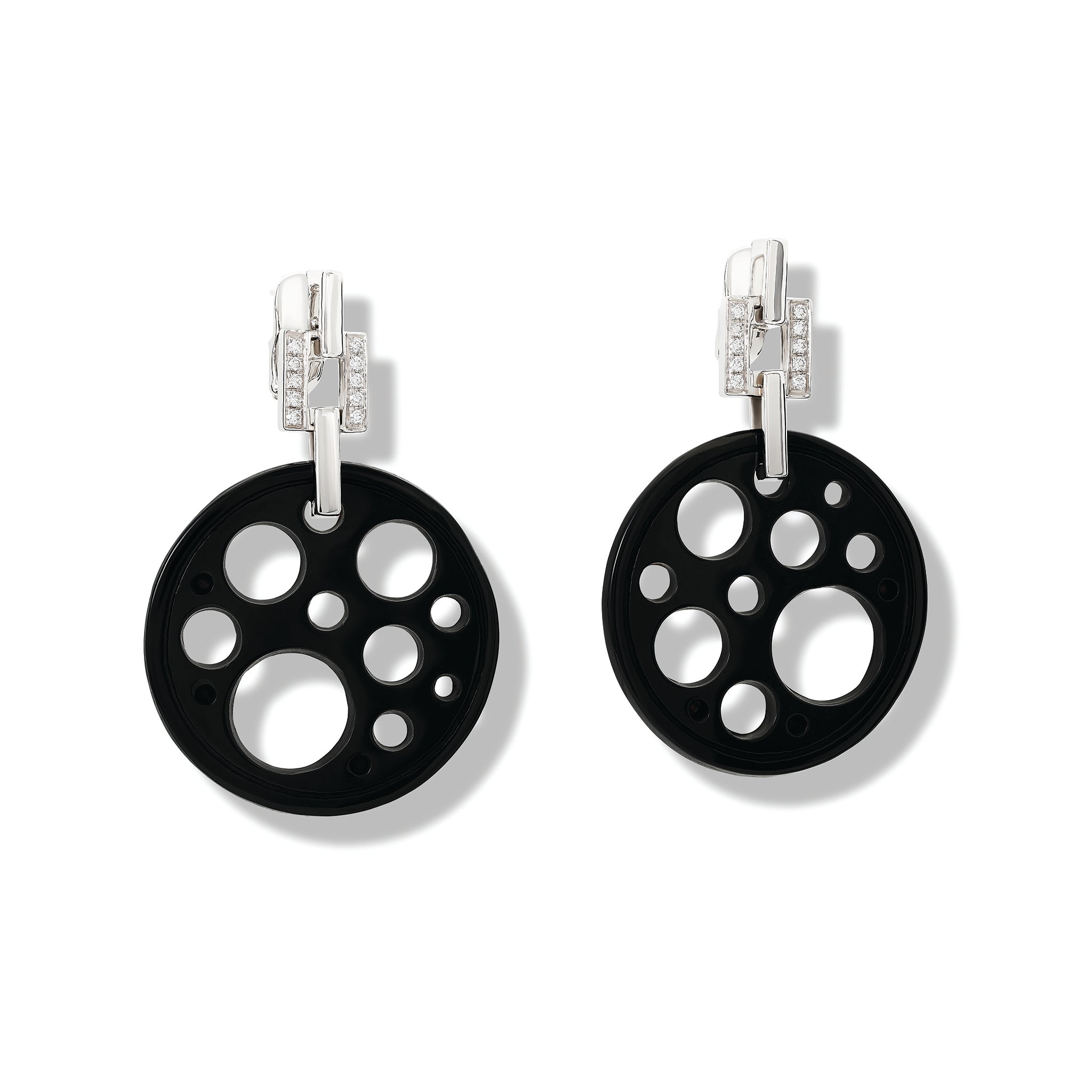 Handcrafted 18ct white gold earrings featuring a circular shape with smaller circular holes of black jade.
