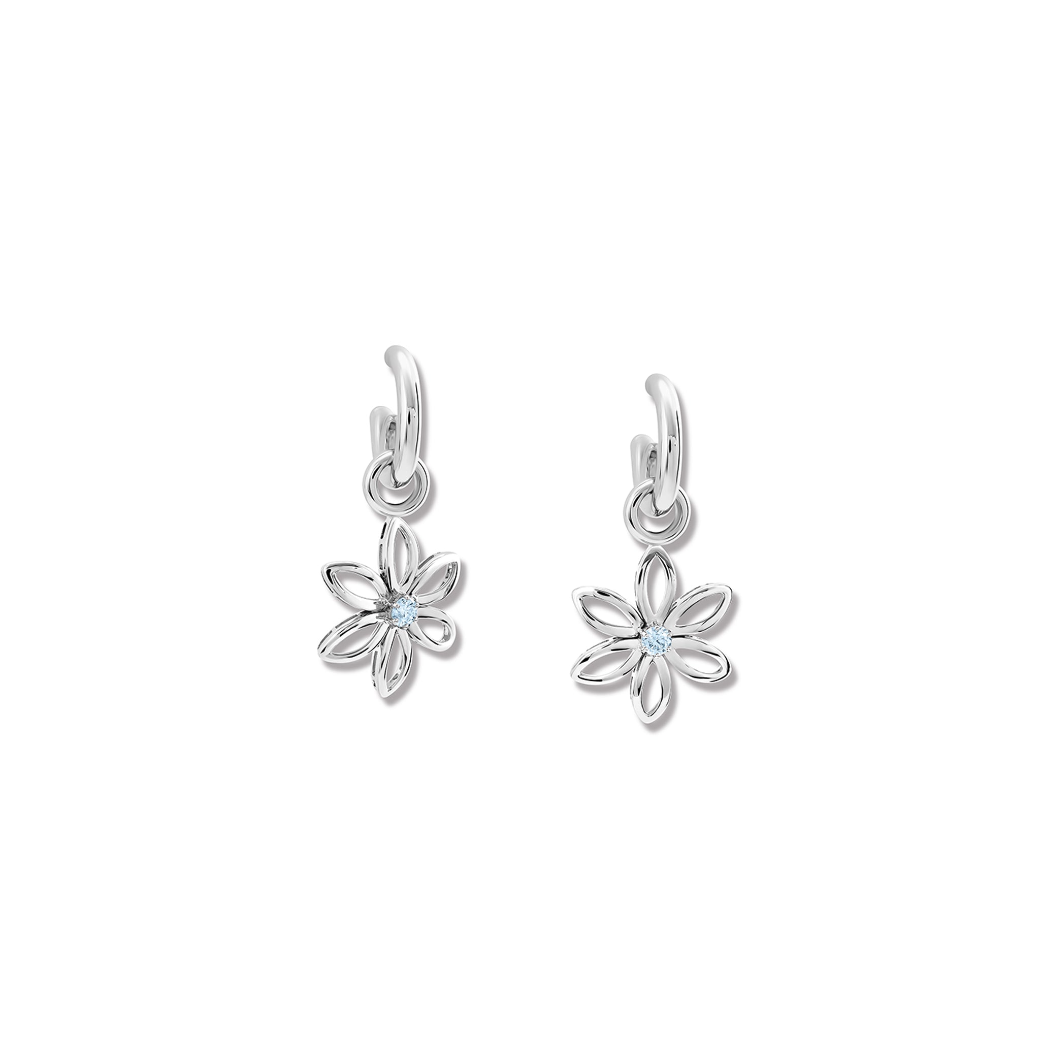 Handcrafted sterling silver flower-shaped earring drops set with blue topaz, birthstone of November, hanging from hoop earrings.