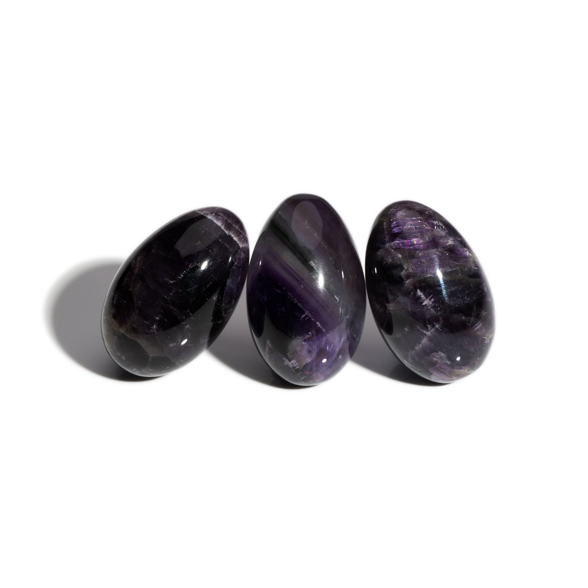 Three handcrafted gemstone eggs in the precious stone amethyst, birthstone of February.