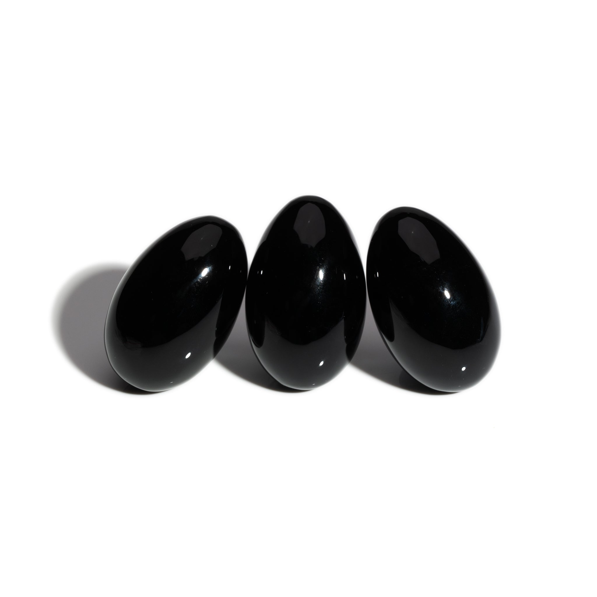 Three handcrafted gemstone eggs in the precious stone obsidian. 