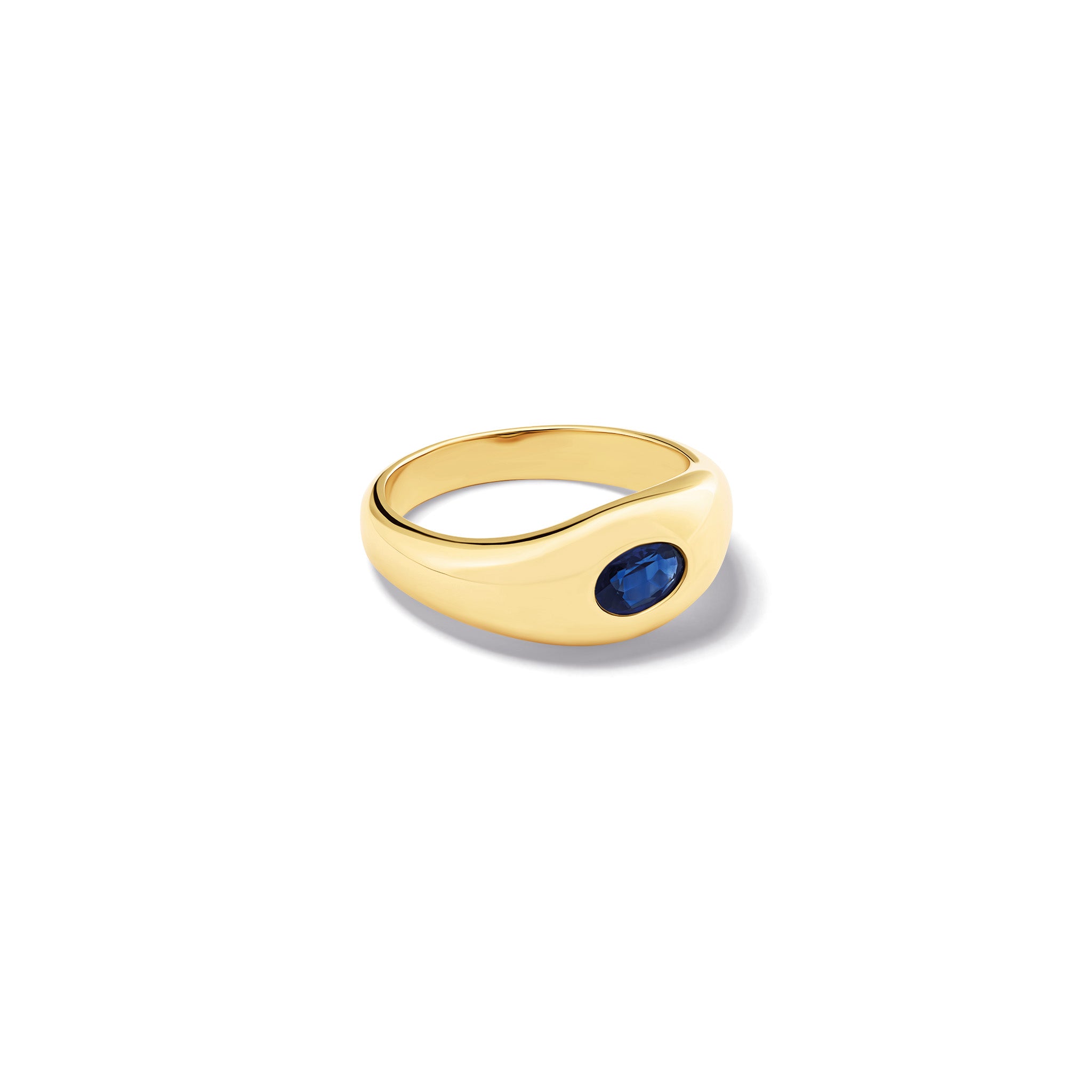 Handcrafted yellow gold ring with a slight teardrop design set with an oval facetted blue sapphire.