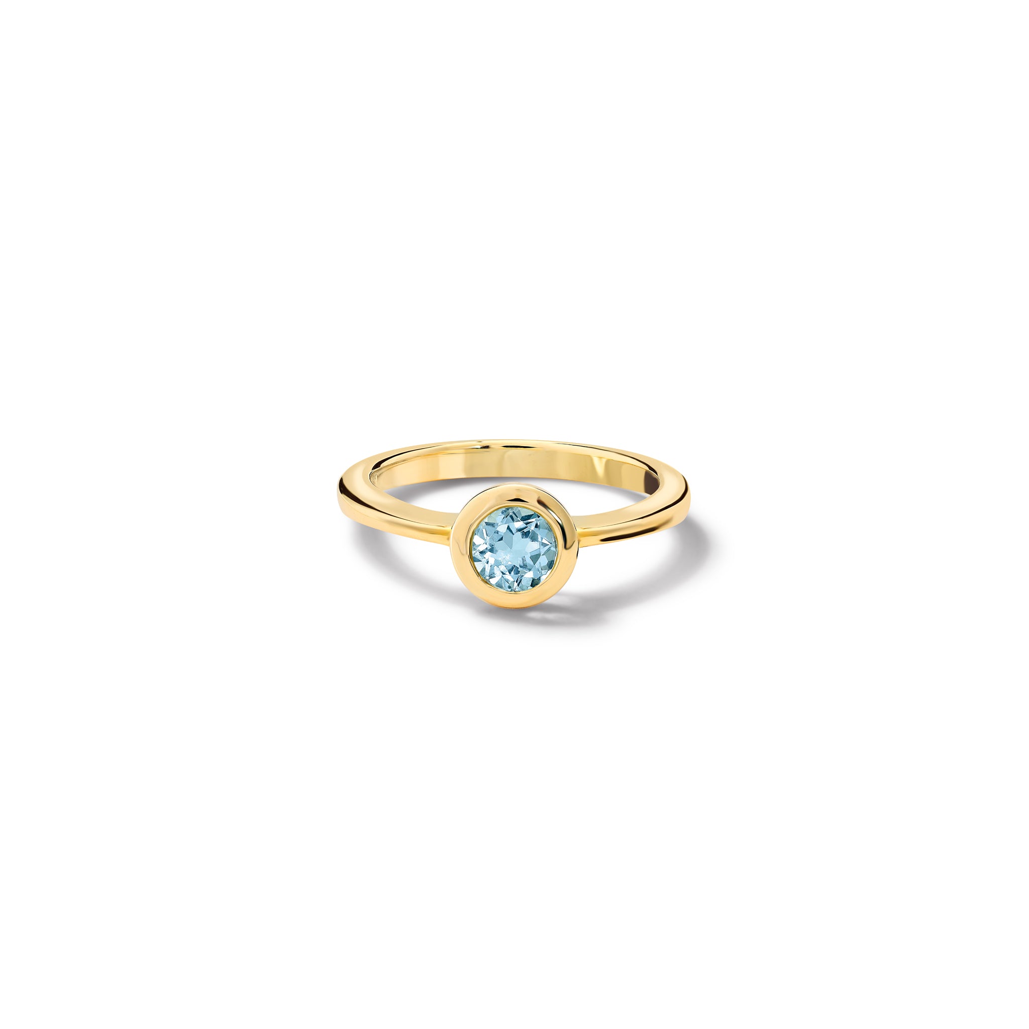 Handcrafted yellow gold ring with a central blue topaz, birthstone of November. 