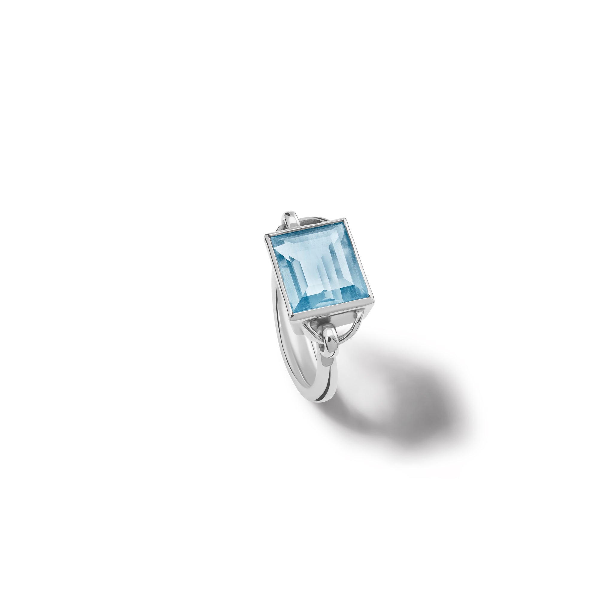 Handcrafted sterling silver ring featuring a central blue topaz, birthstone of November.