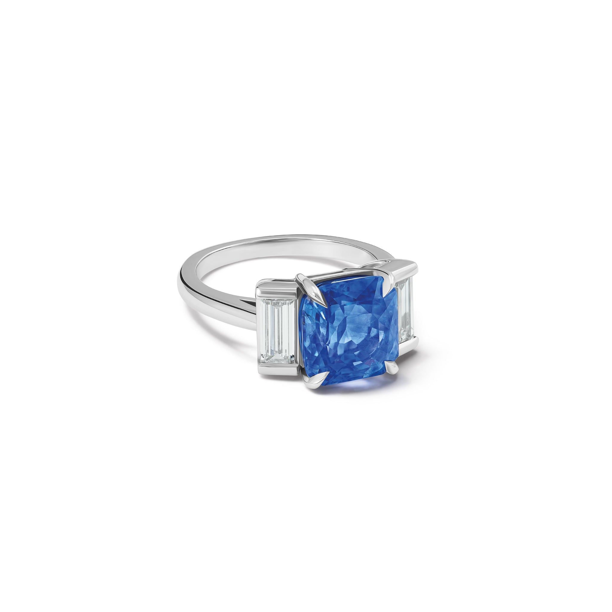 Handcrafted platinum engagement ring featuring a central rectangular blue sapphire flanked by two smaller rectangular diamonds on each side, all set in a sleek band.