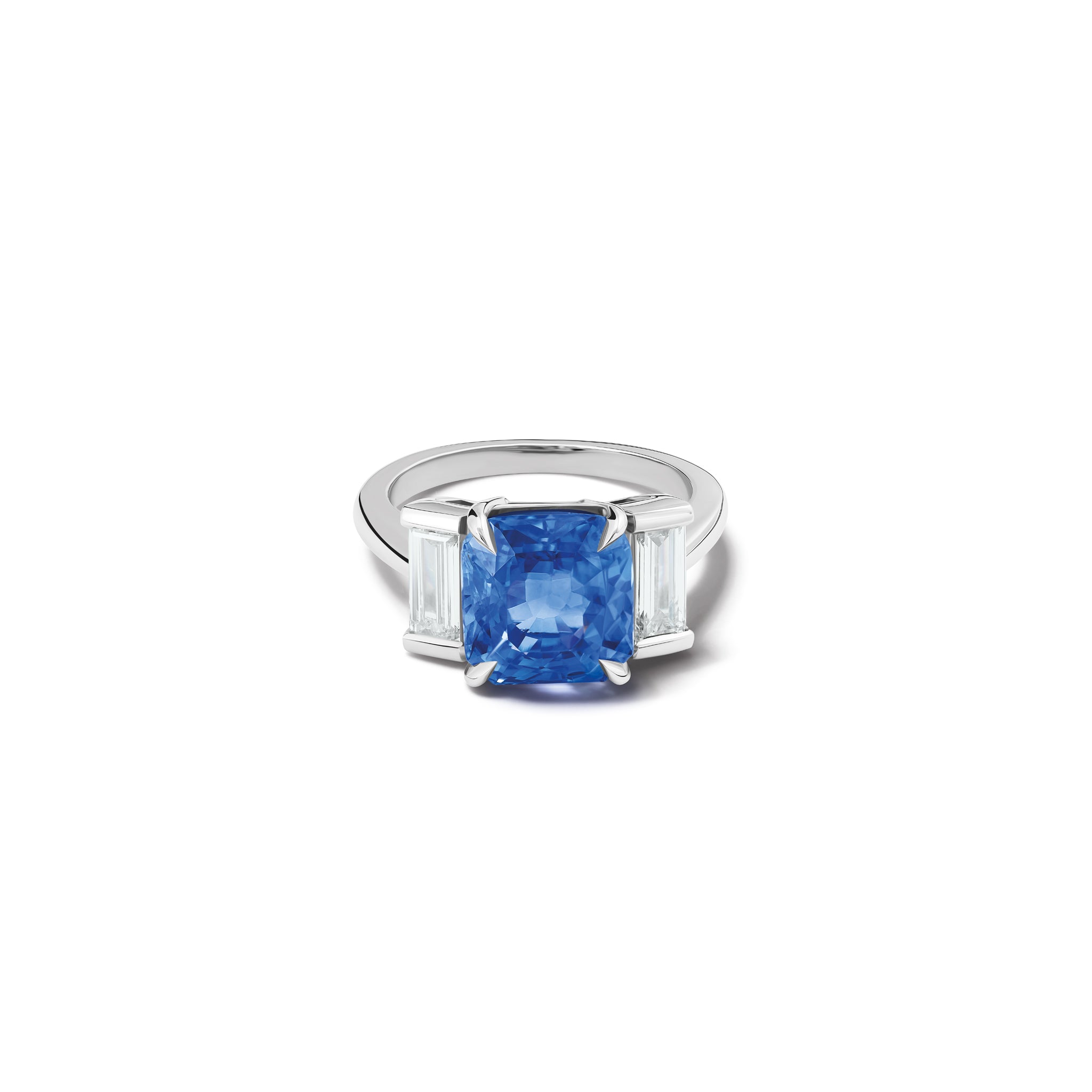 Handcrafted platinum engagement ring featuring a central rectangular blue sapphire flanked by two smaller rectangular diamonds on each side, all set in a sleek band.