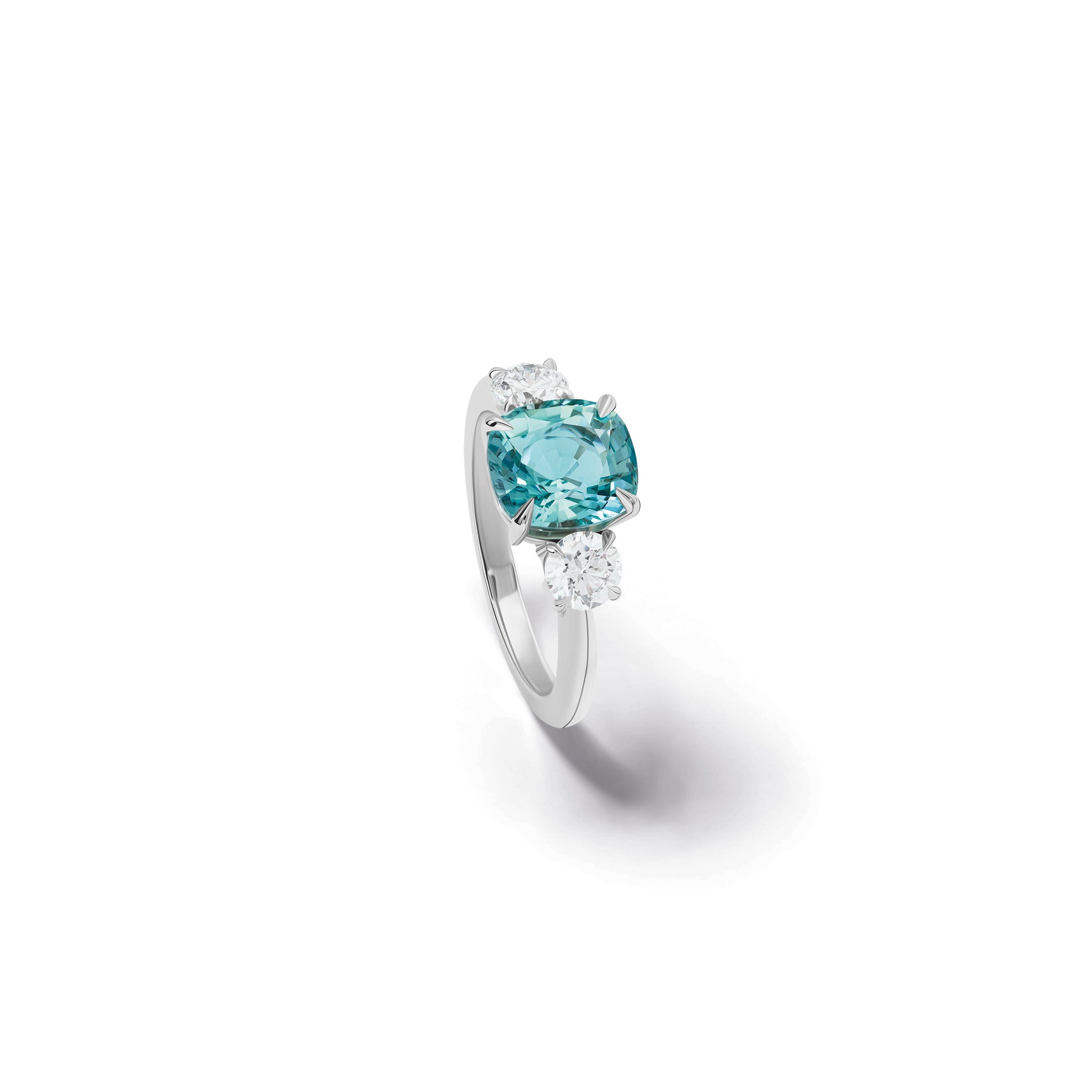 Handmade 18ct white gold engagement ring featuring a large, cushion cut aquamarine at its center, surrounded by two smaller teardrop-shaped white diamonds.