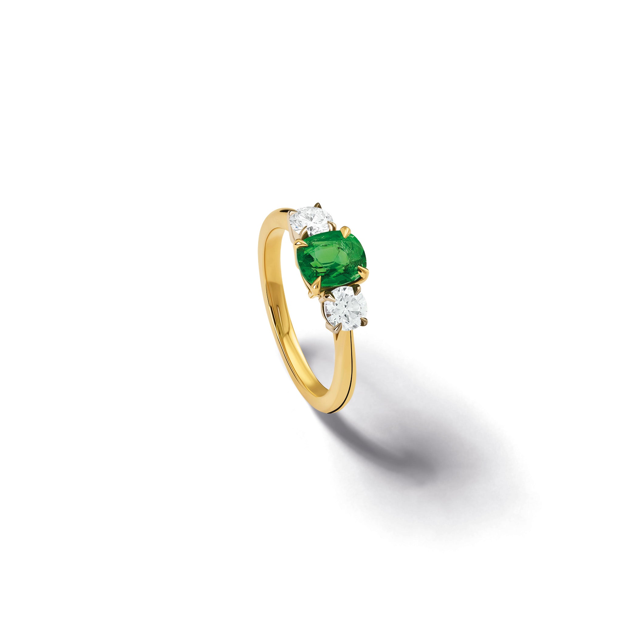 Handmade 18ct yellow gold engagement ring featuring a large, cushion cut tsavorite garnet at its center, surrounded by two smaller teardrop-shaped white diamonds.