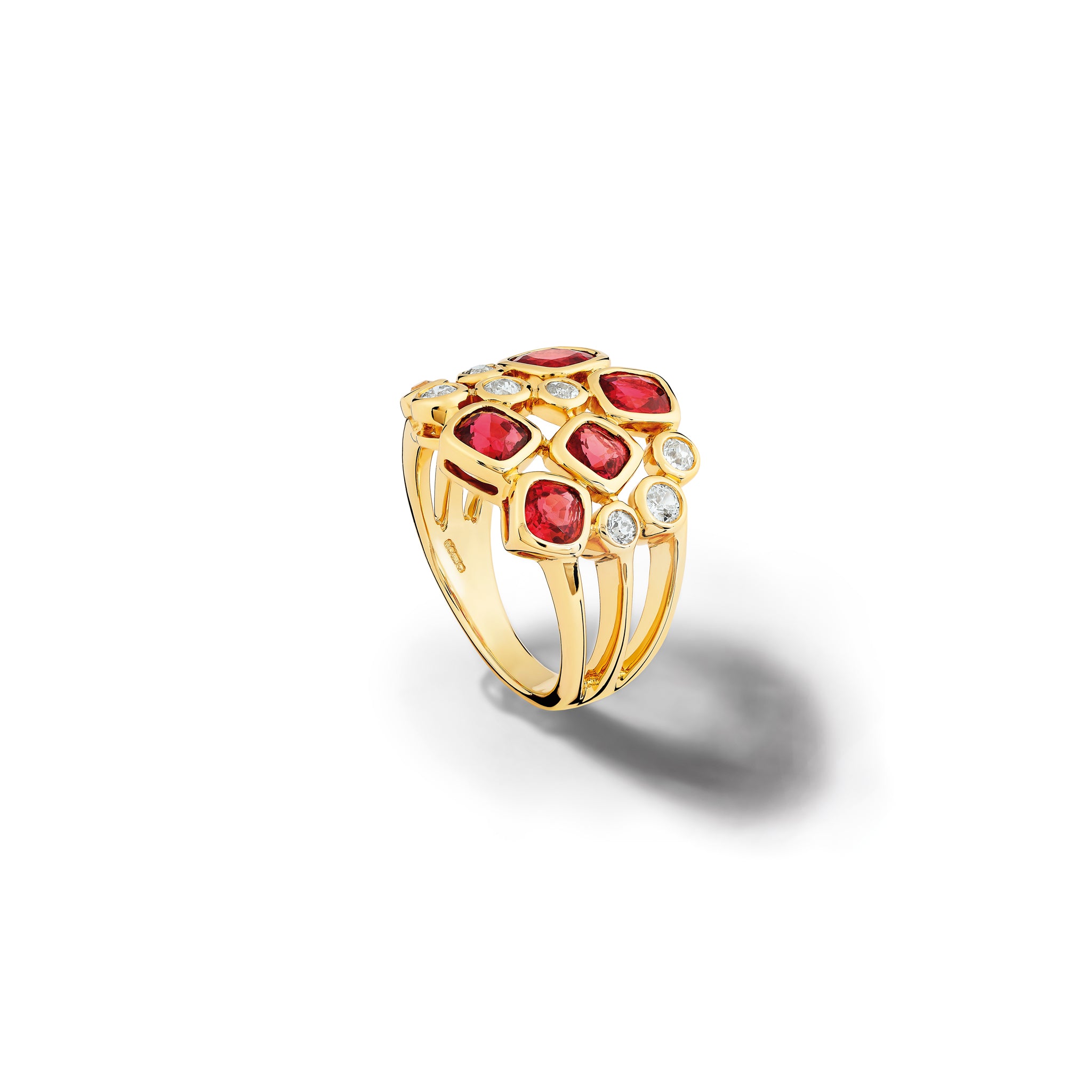 Handcrafted 18ct yellow gold ring featuring different sized round red spinels and diamonds. 