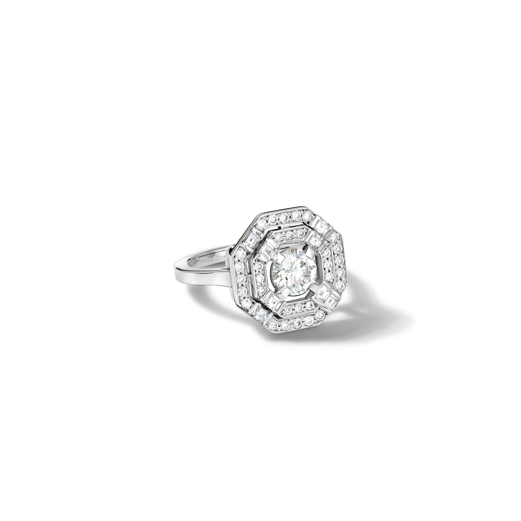 Handcrafted 18ct white gold engagement ring featuring a central square-cut central diamond, surrounded by two tiers of small round diamonds set in a hexagonal pattern. 