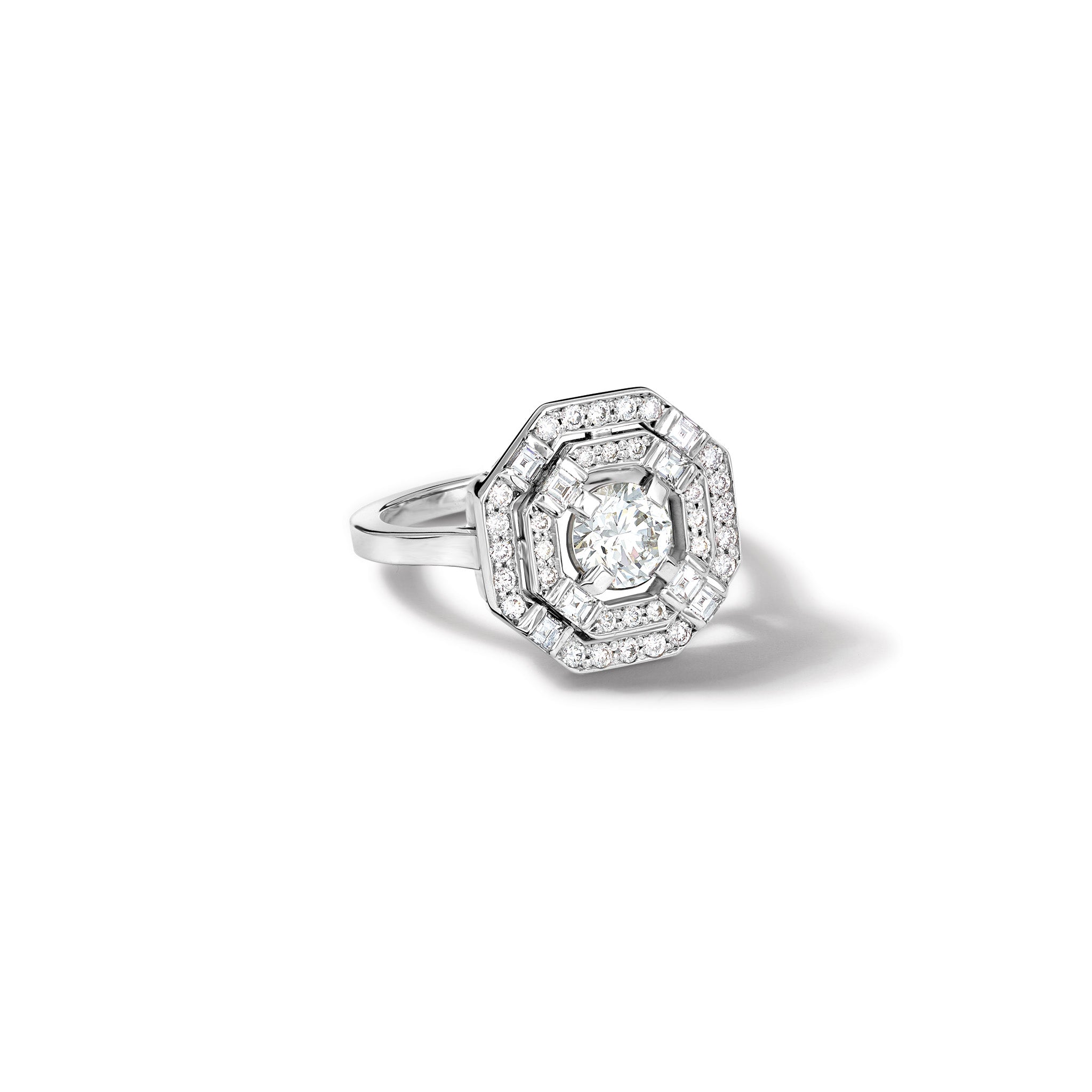 Handcrafted 18ct white gold engagement ring featuring a central square-cut central diamond, surrounded by two tiers of small round diamonds set in a hexagonal pattern.