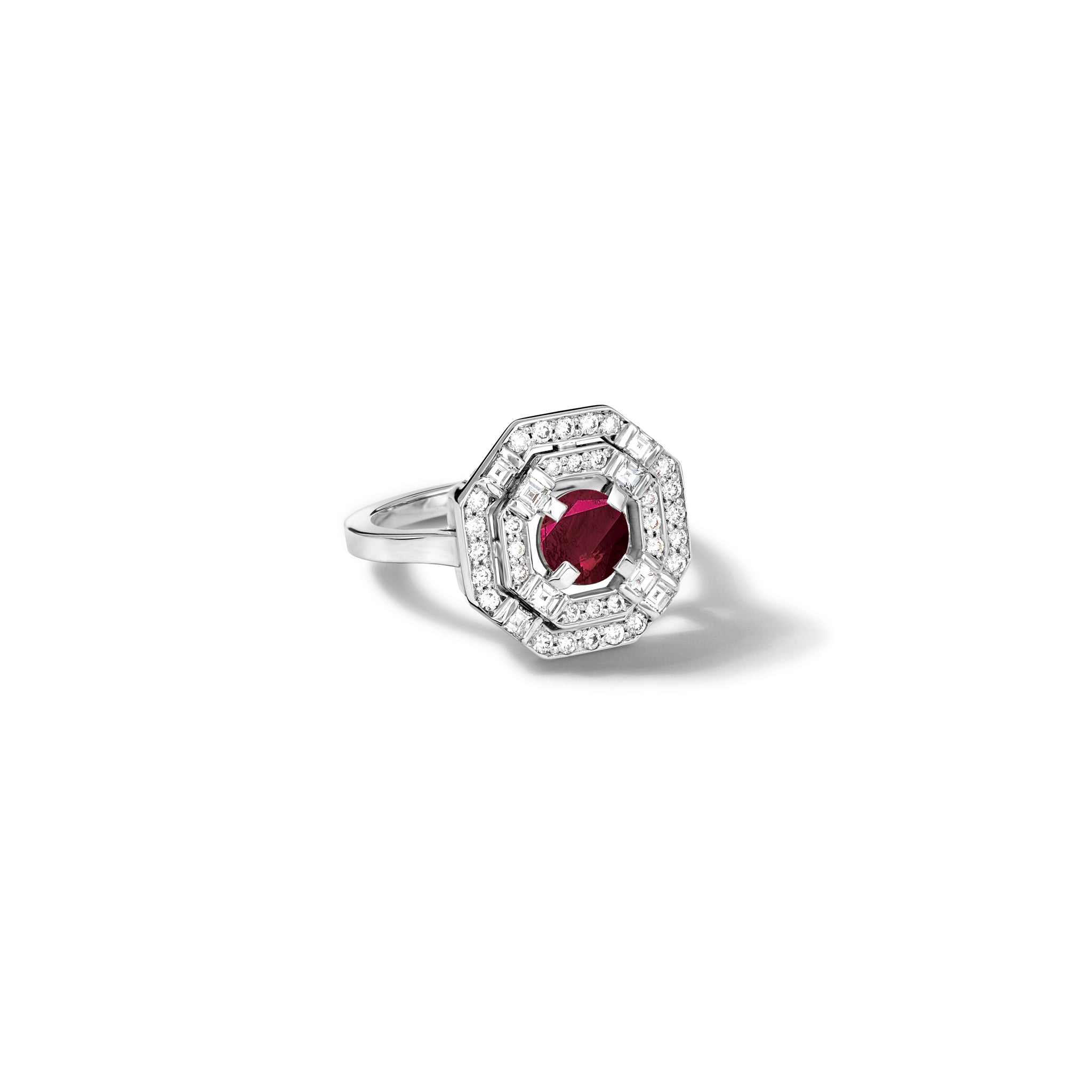 Handcrafted 18ct white gold engagement ring featuring a central square-cut ruby, surrounded by two tiers of small round diamonds set in a hexagonal pattern. 