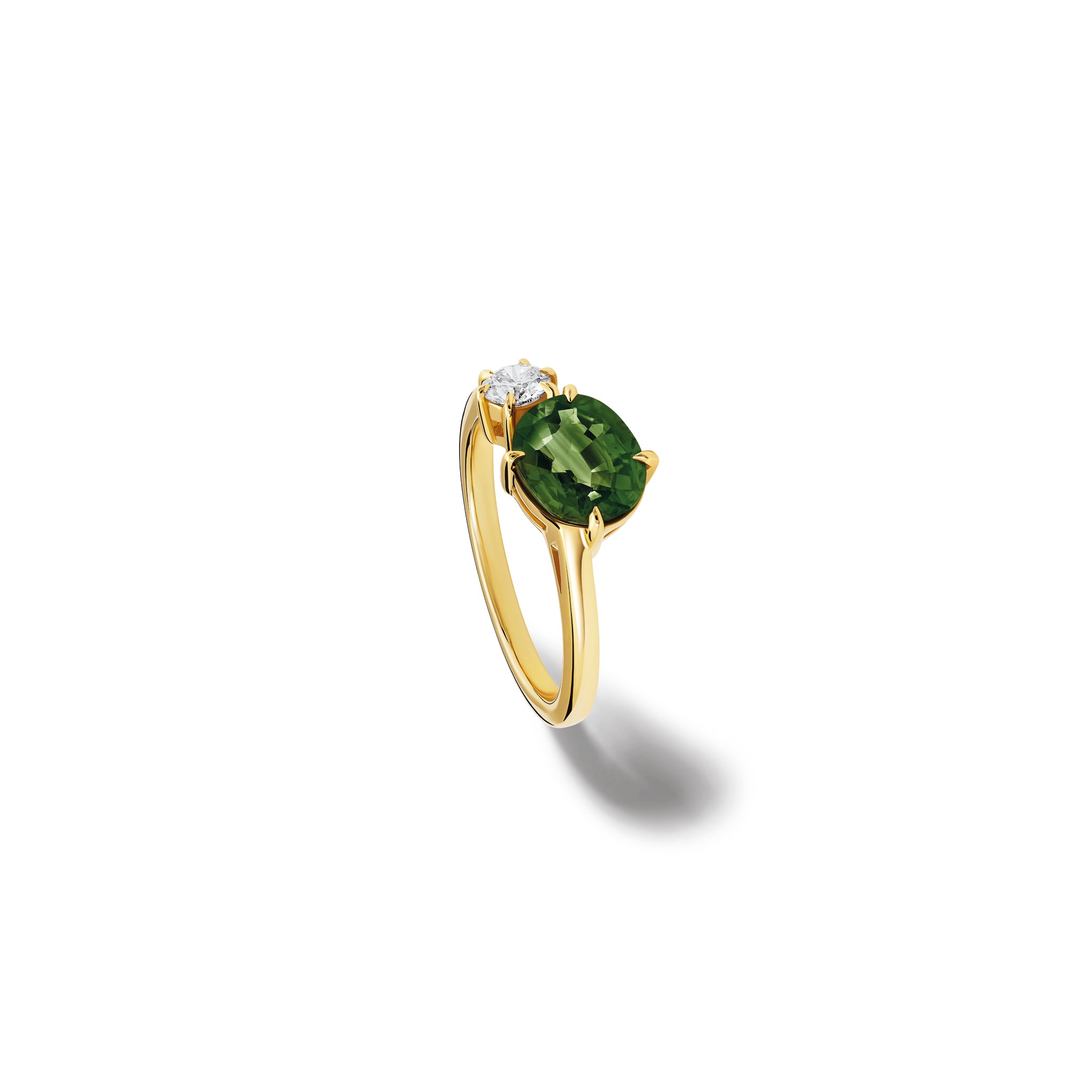 Handcrafted 18ct yellow gold engagement ring featuring two prominent stones: an oval green sapphire on the left and a round diamond on the right.