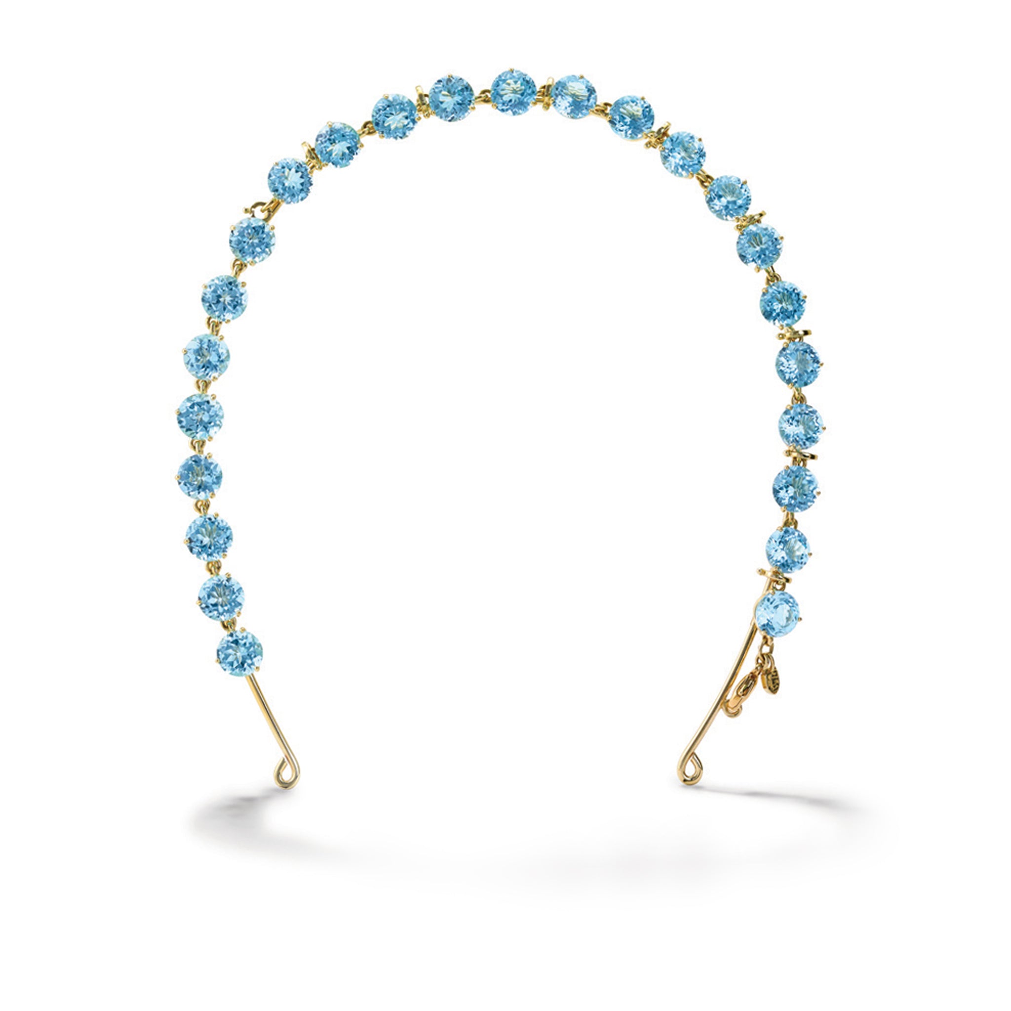 Handcrafted yellow gold tiara featuring circular blue topaz gemstones.
