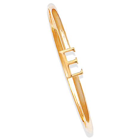 Handcrafted yellow gold bangle with a central yellow gold letter E accent.