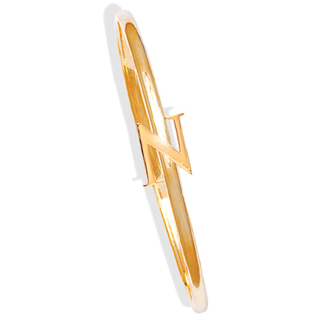 Handcrafted yellow gold bangle with a central yellow gold letter N accent.