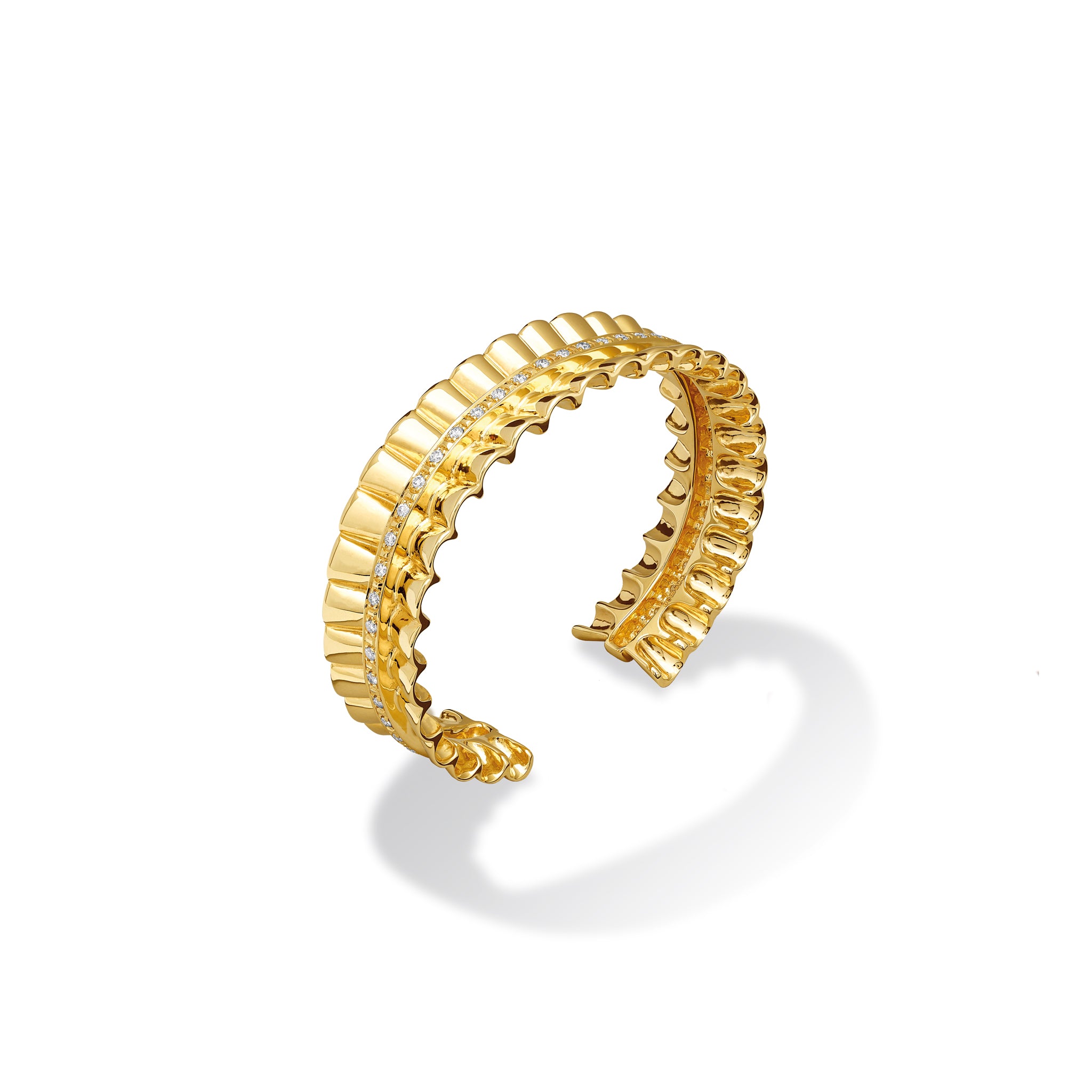 Handcrafted yellow gold cuff bracelet featuring an undulating ribbon shape with diamonds.
