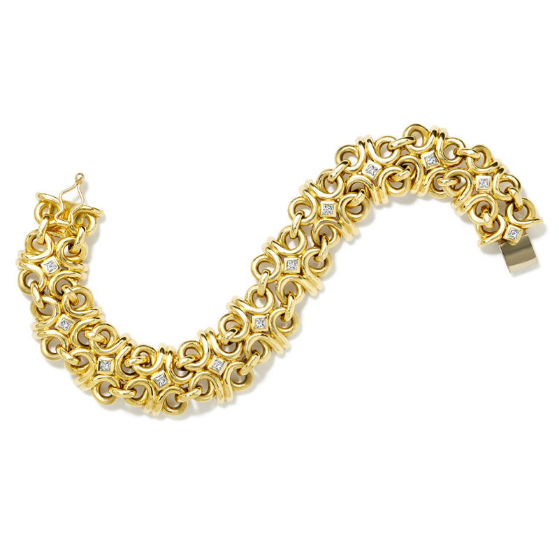 Handcrafted 18ct yellow gold bracelet with bold curls of intertwined golden strands, accented with gold and square-cut diamonds.