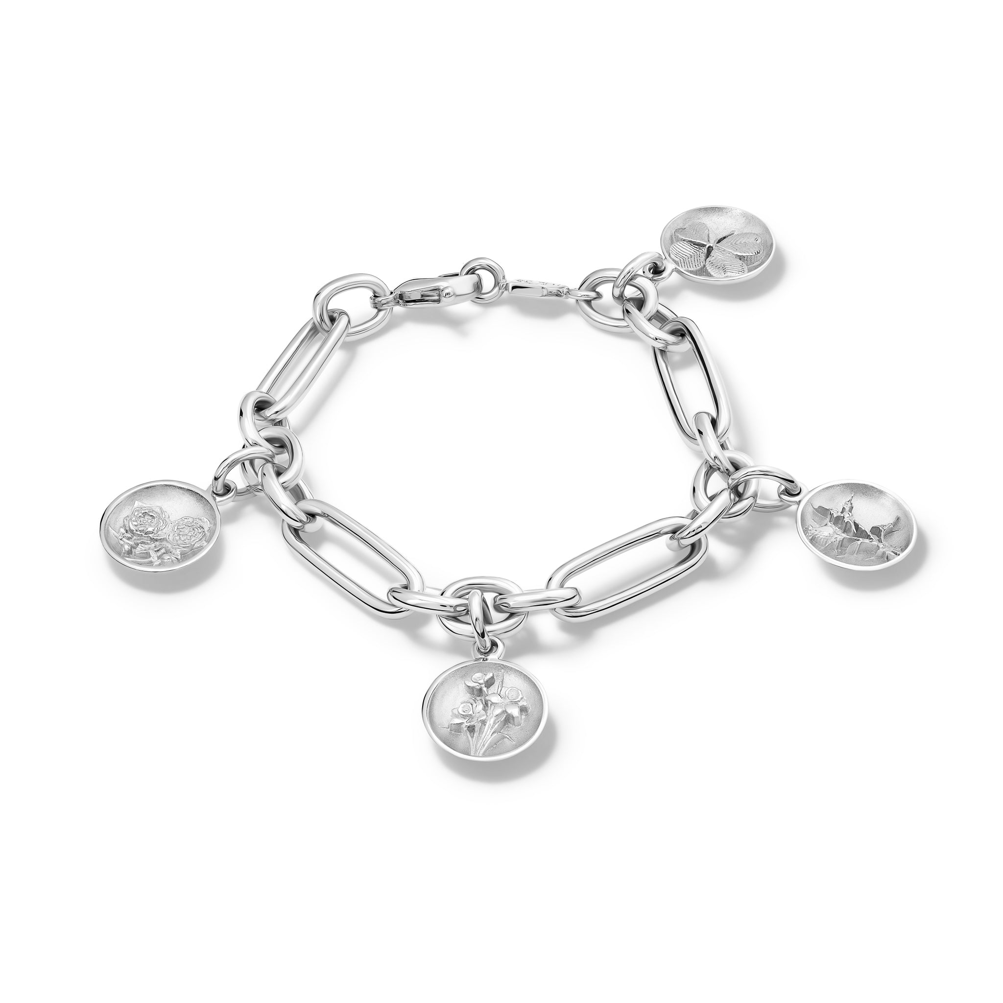 Handcrafted link bracelet in sterling silver with four round charms 'en relief' with the rose, the daffodil, the thistle, and the shamrock.