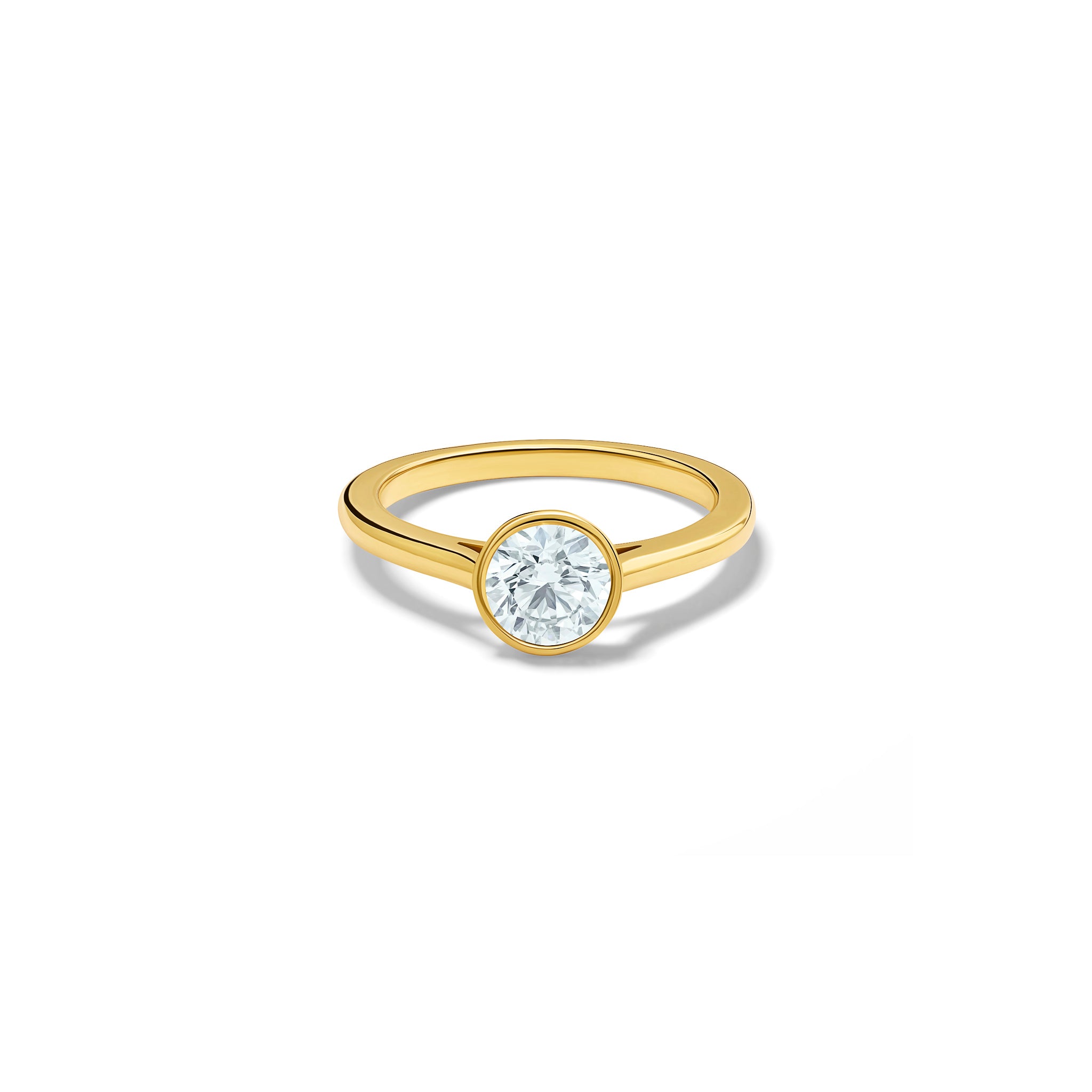 Handmade 18ct yellow gold engagement ring featuring a round central diamond in a rub over setting.