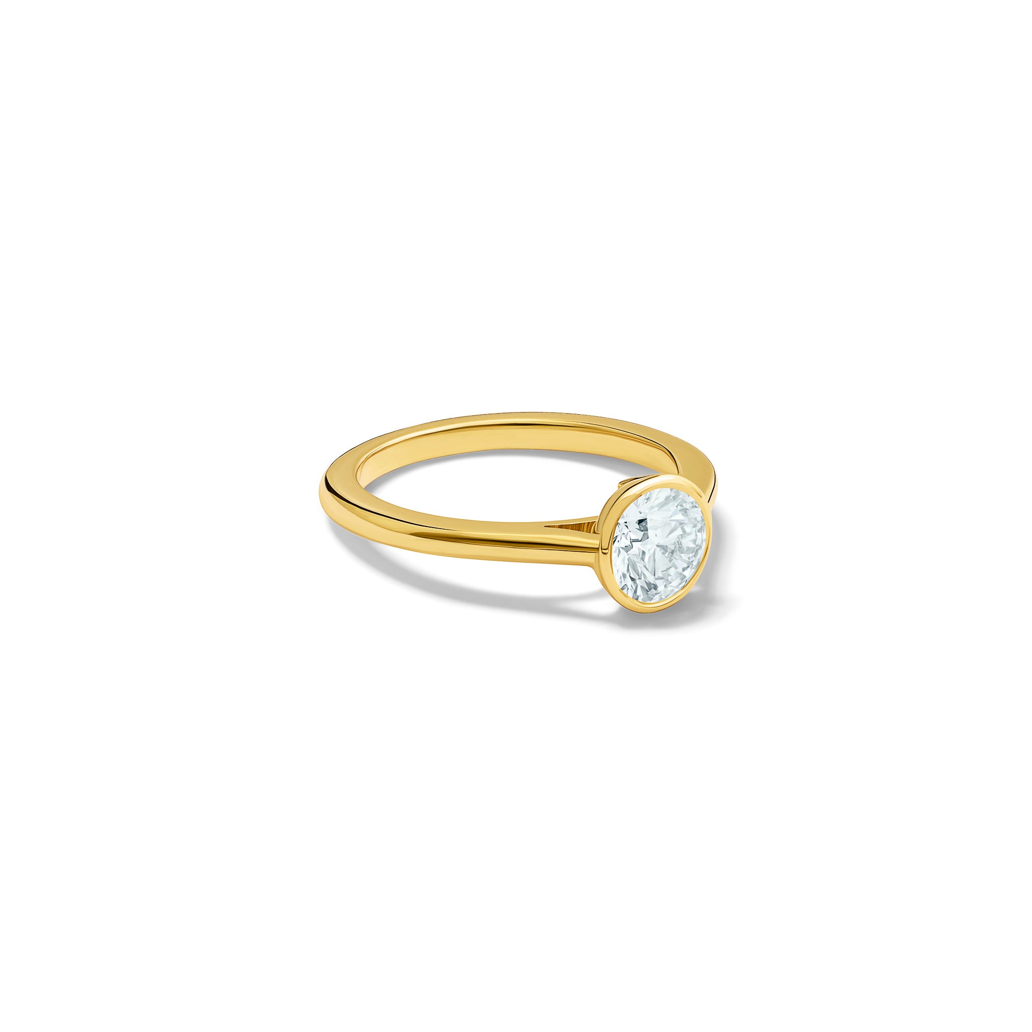 Handmade 18ct yellow gold engagement ring featuring a round central diamond in a rub over setting.