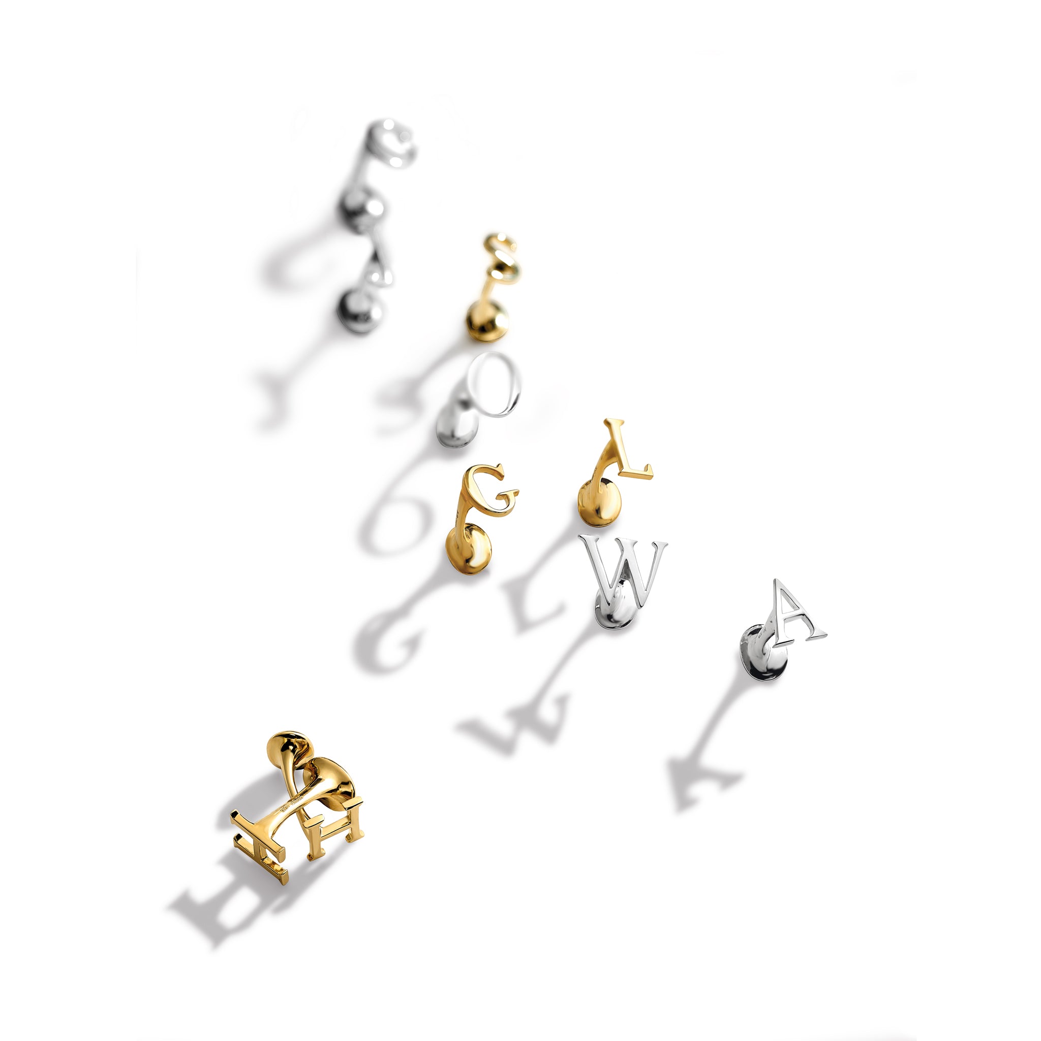 Handcrafted single ended cufflinks in sterling silver and yellow gold featuring silver and yellow gold initials.