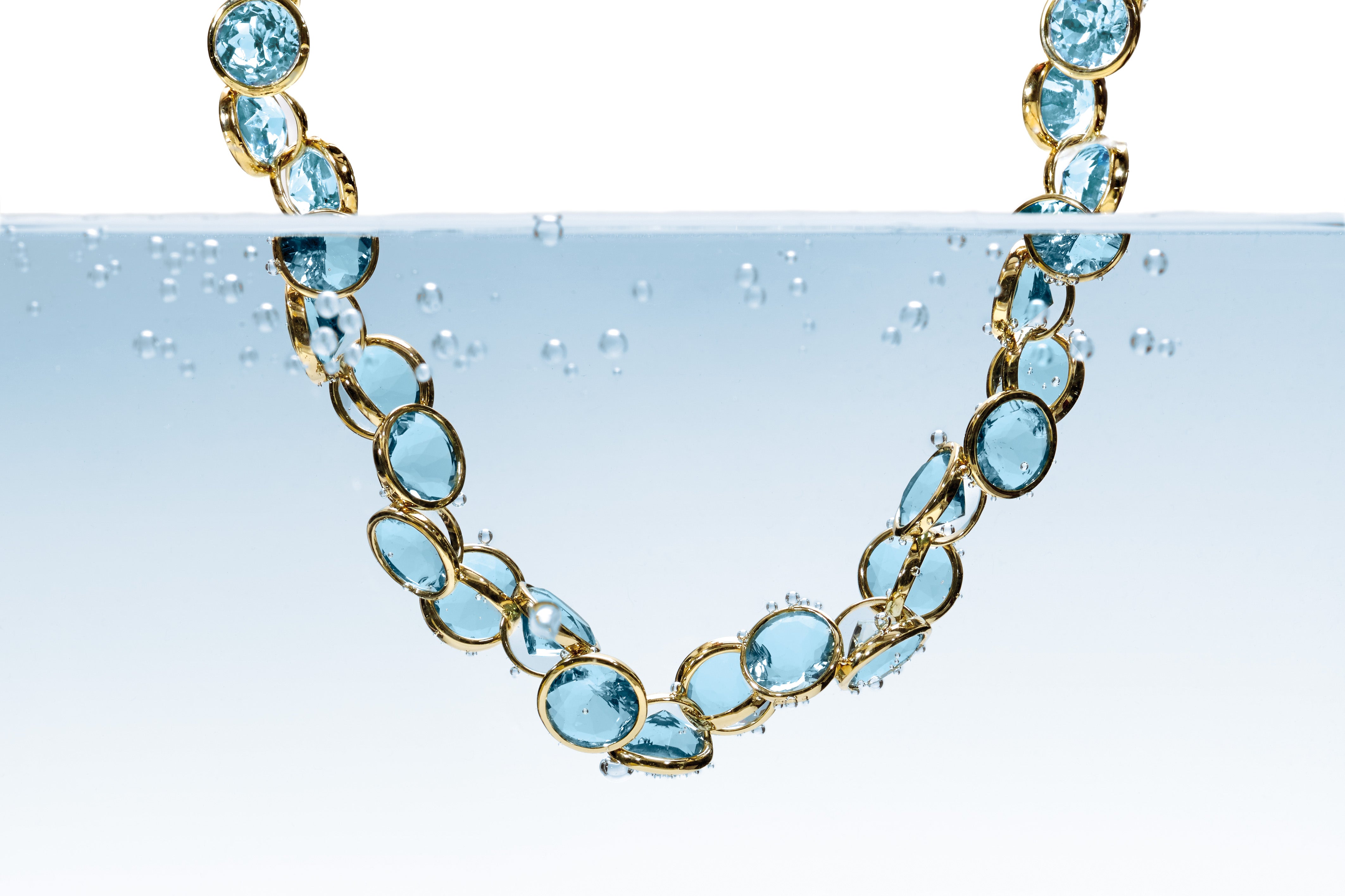 Handcrafted yellow gold necklace with precious blue gemstones.